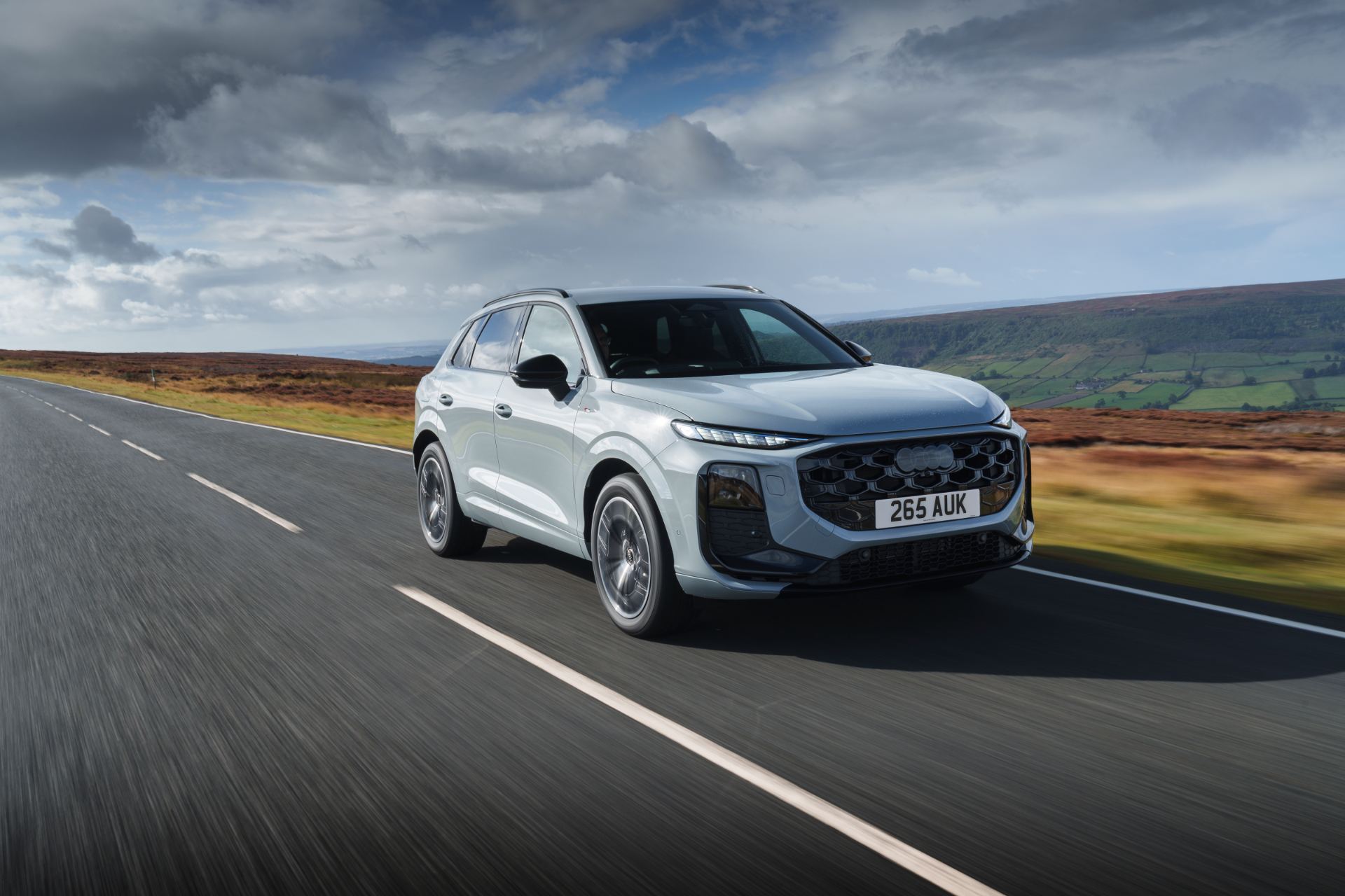 2026 audi q3 driving front three quarter moorland road silver