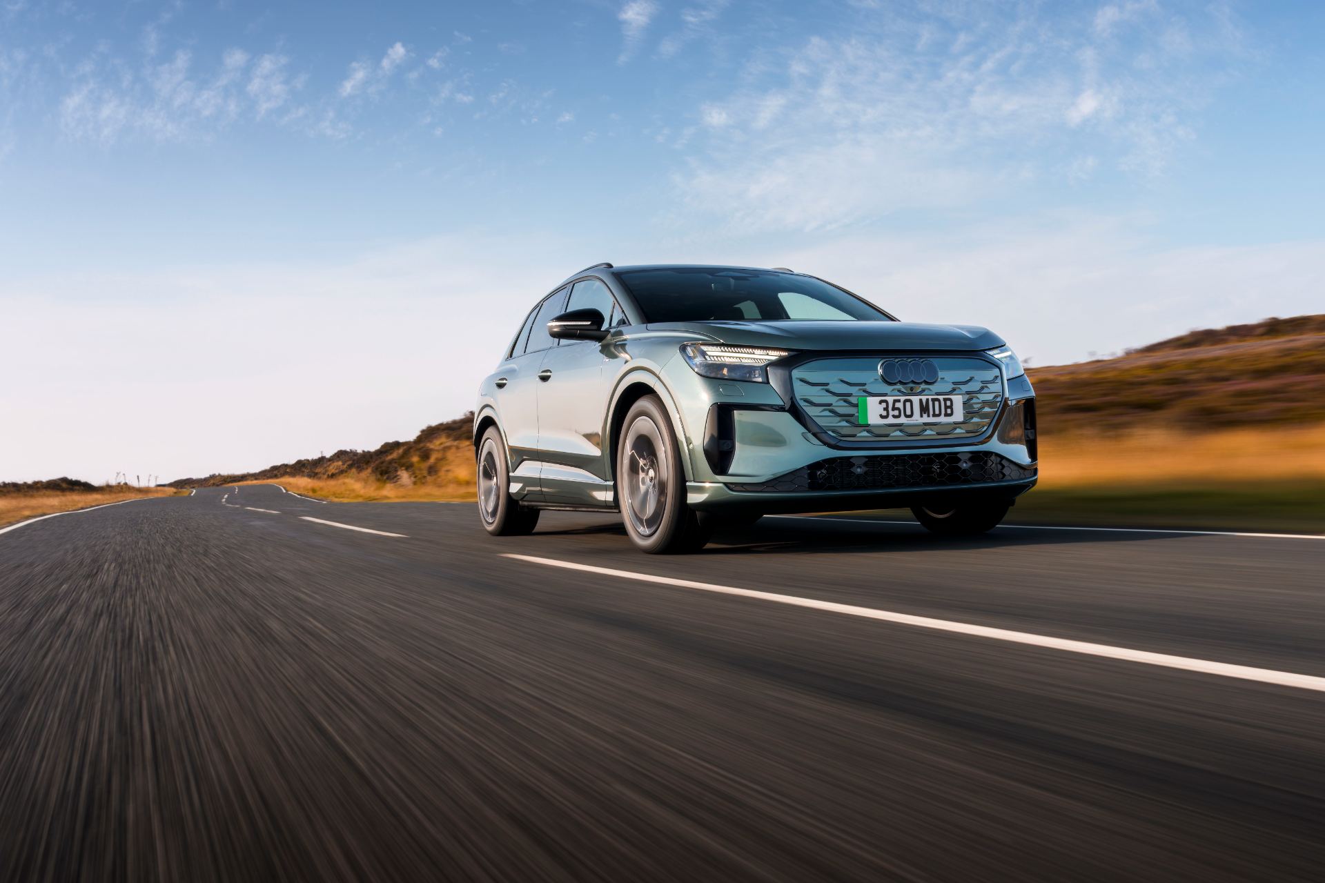 2026 audi q4 e tron driving front three quarter low angle green