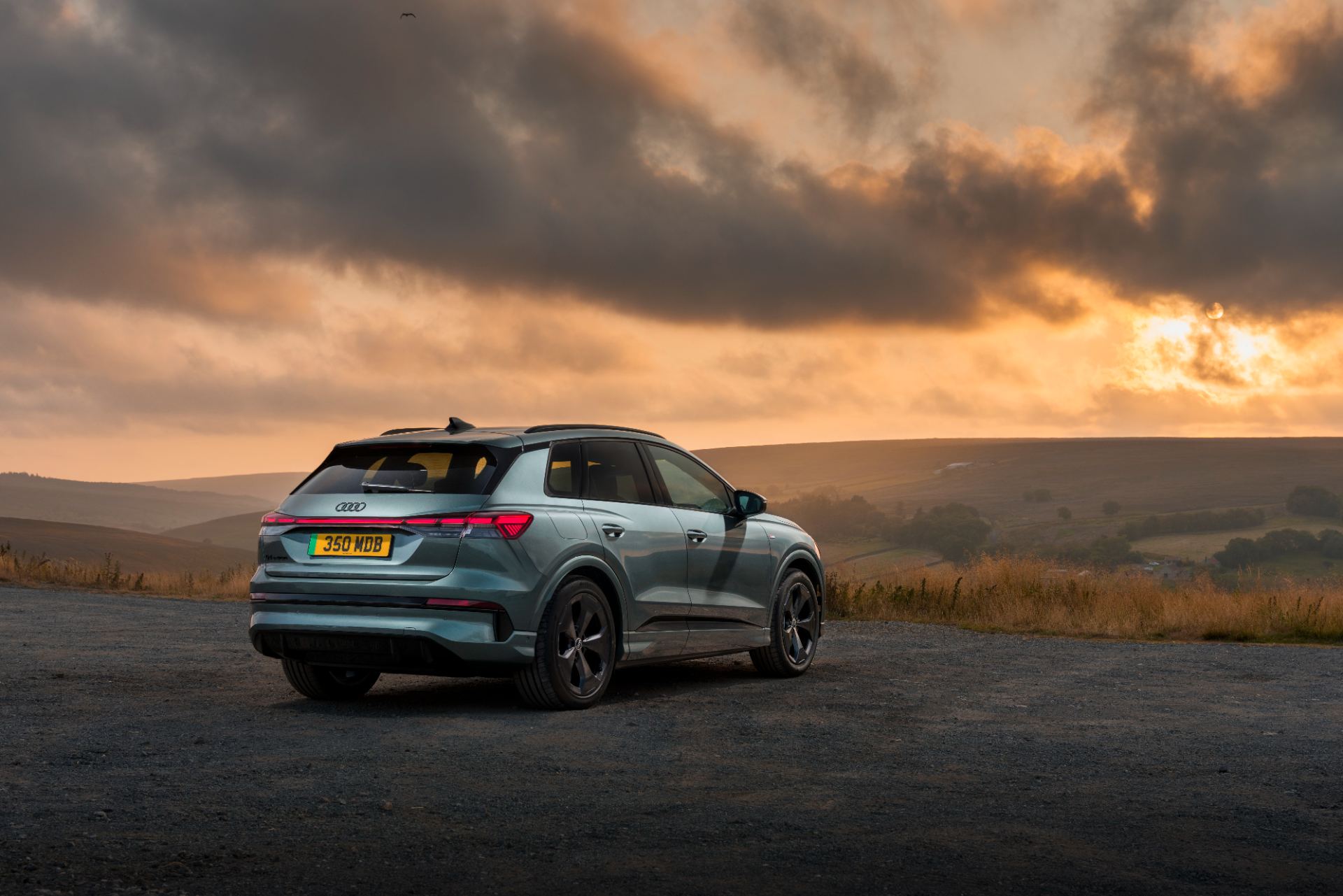 2026 audi q4 e tron rear three quarter sunset green