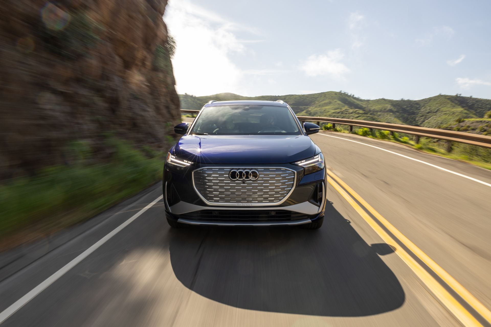 2026 audi q4 e tron driving front canyon road blue