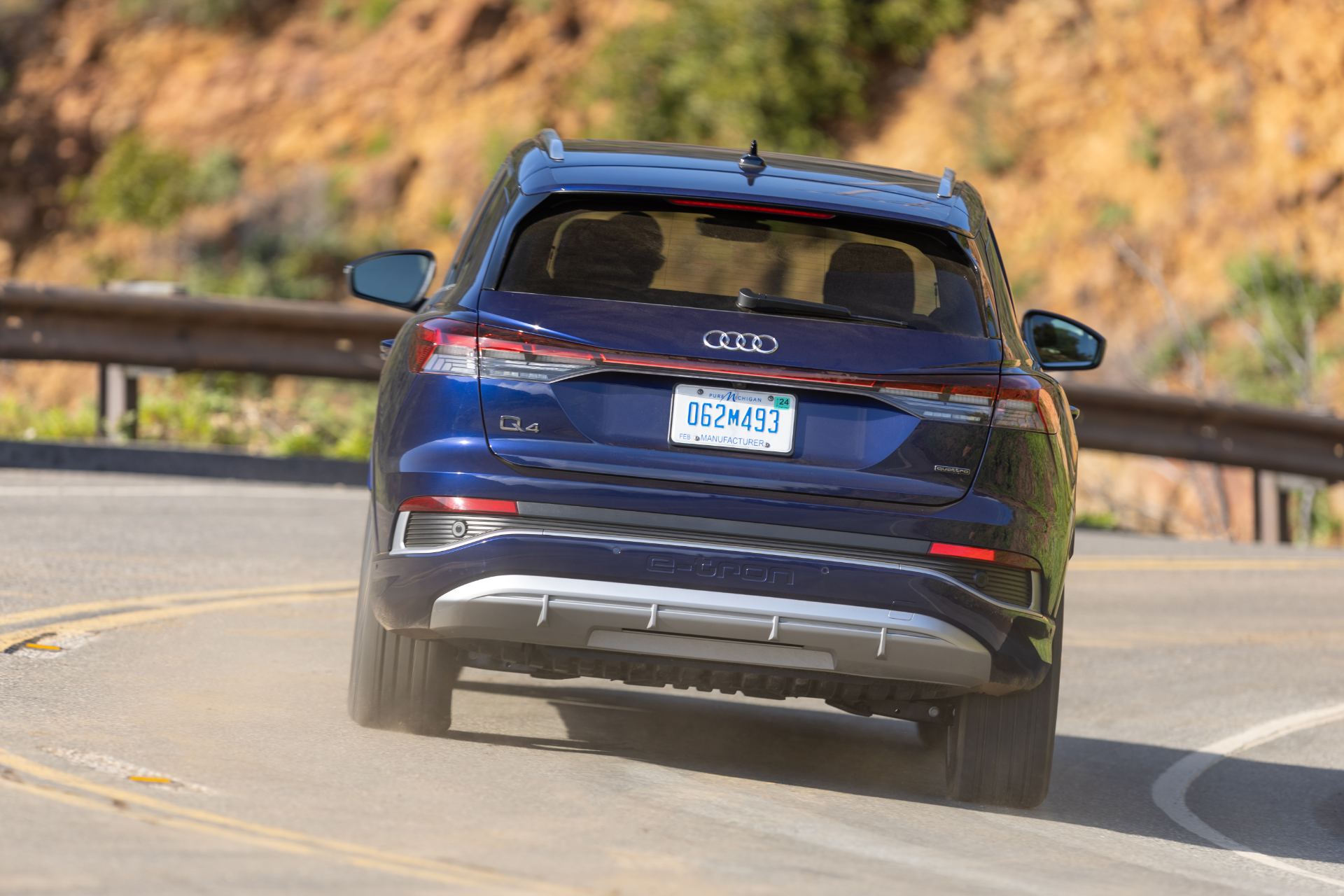 2026 audi q4 e tron driving rear canyon road blue
