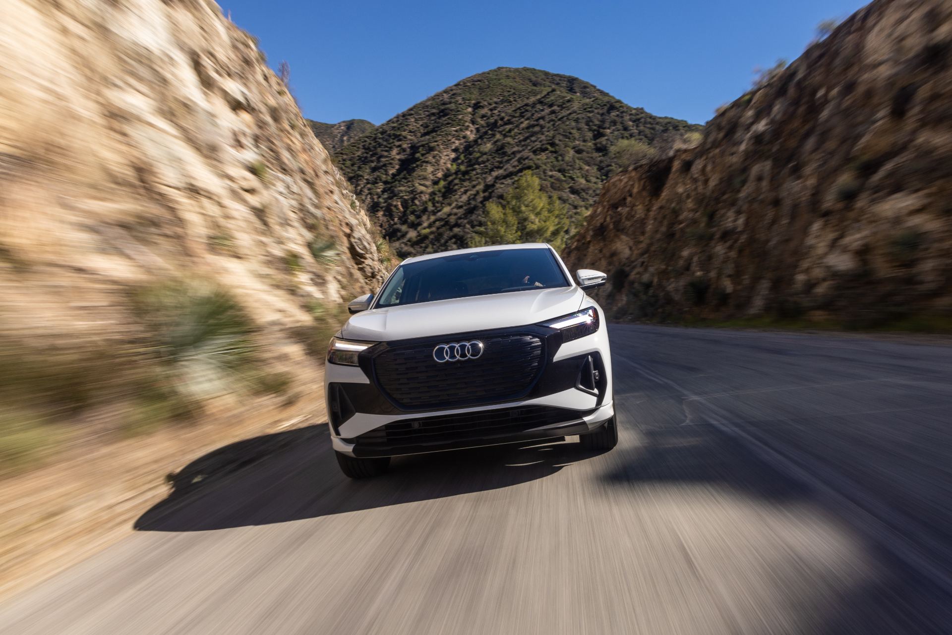 2026 audi q4 sportback e tron driving front canyon white