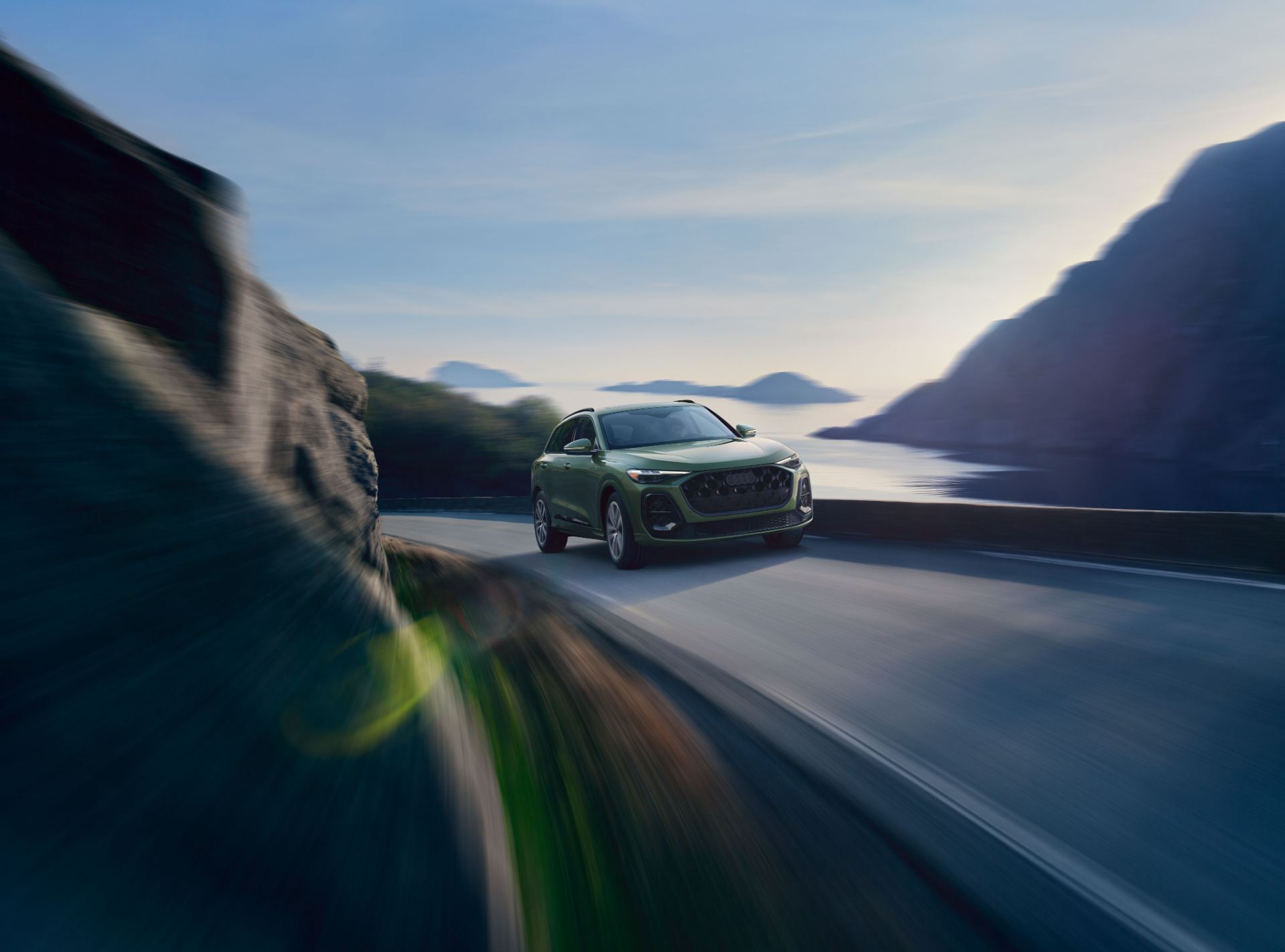 2026 audi q5 driving front three quarter coast green