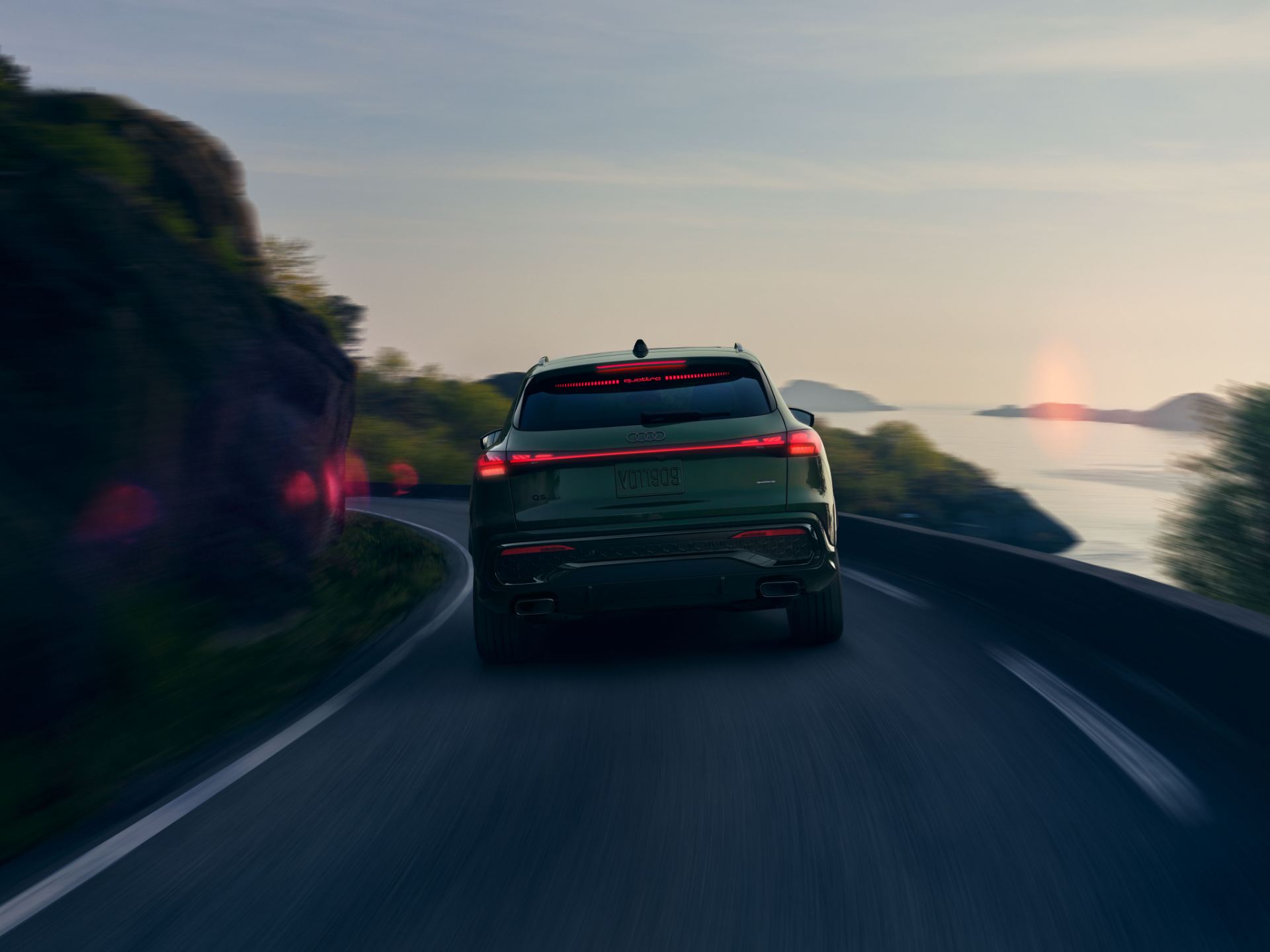 2026 audi q5 driving rear coastal road green