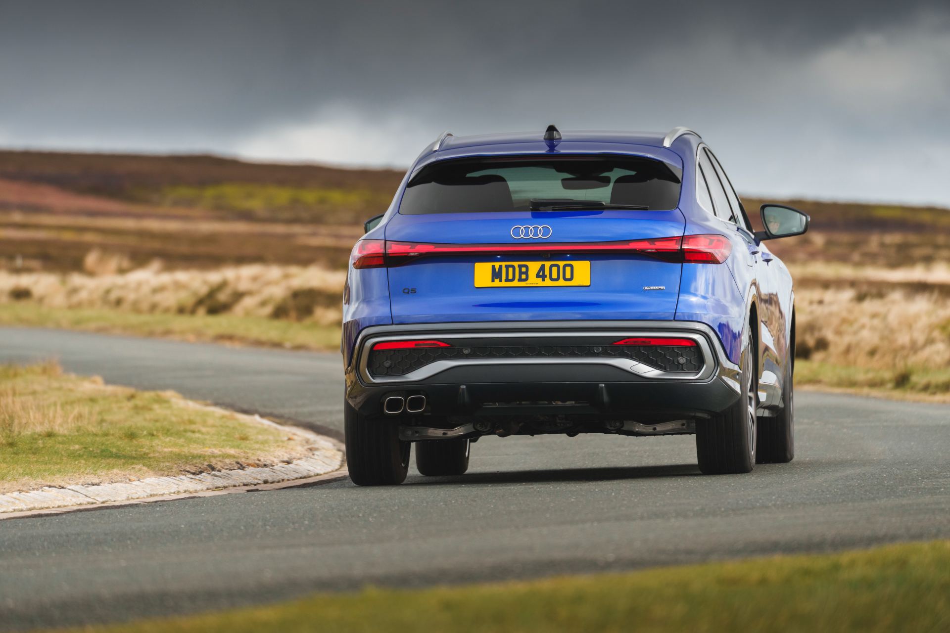 2026 audi q5 sportback e hybrid driving rear blue