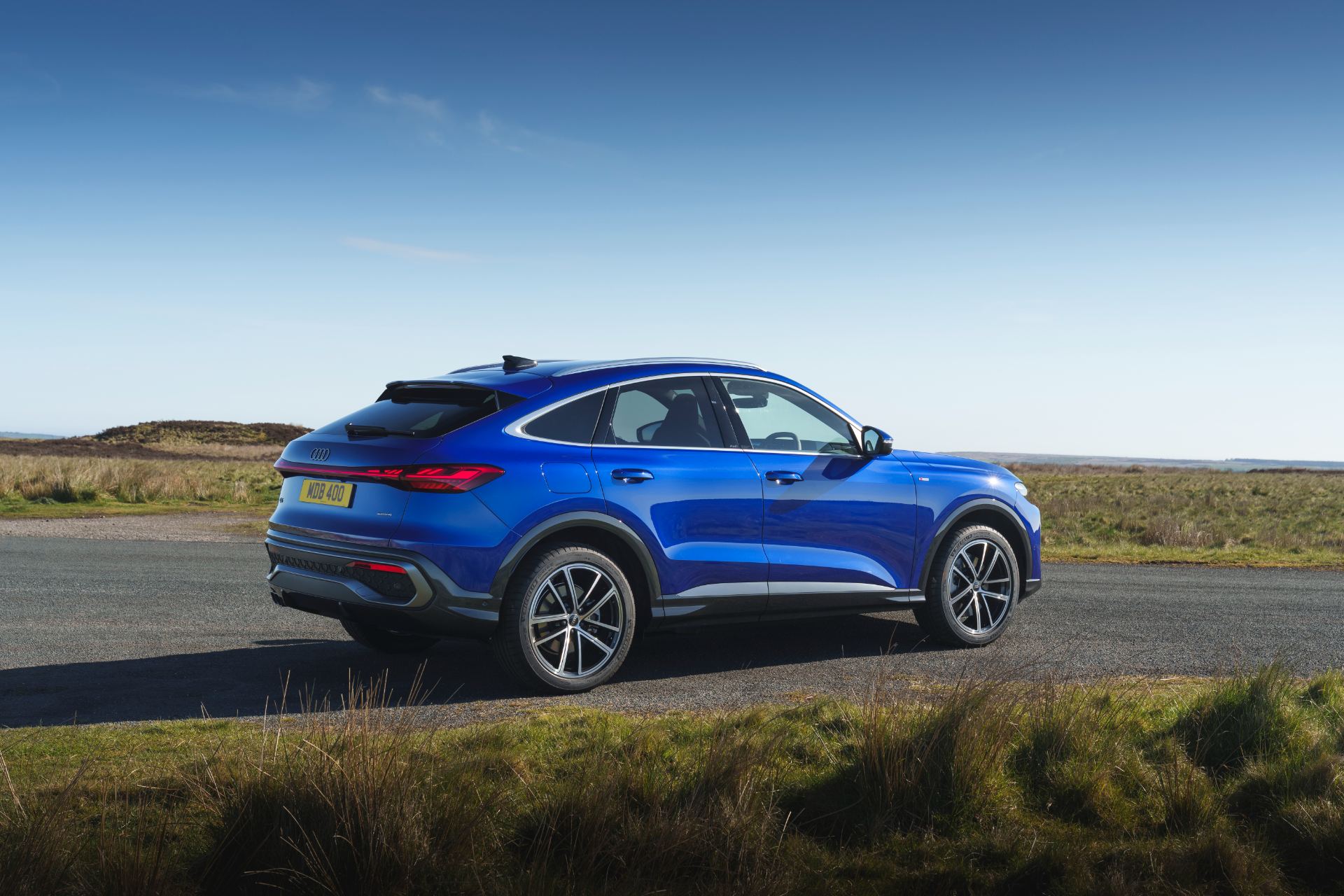 2026 audi q5 sportback e hybrid rear three quarter blue