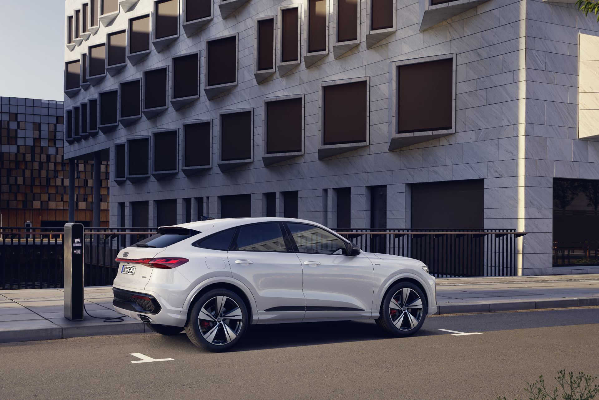 2026 audi q5 sportback e hybrid rear three quarter charging station white