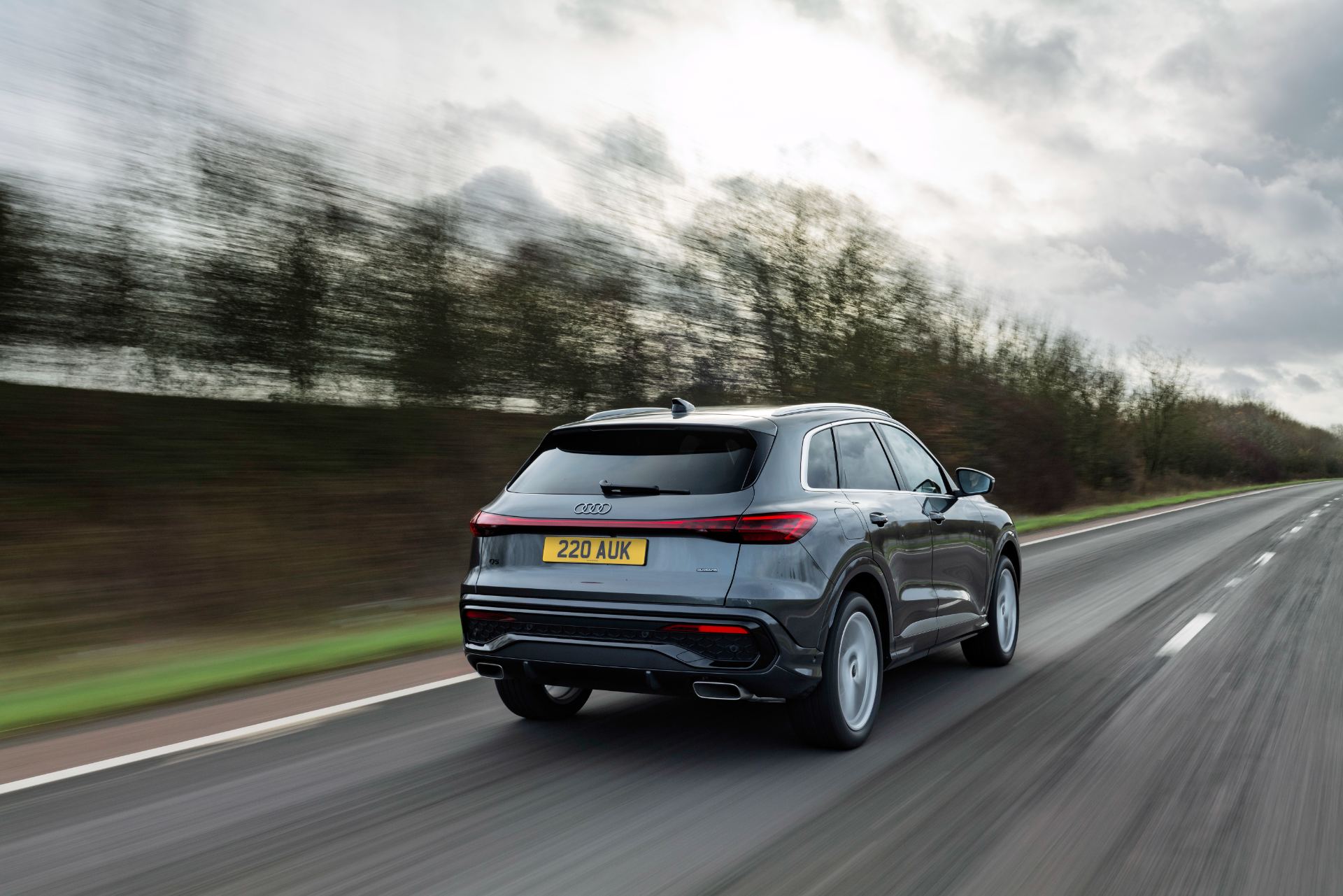 2026 audi q5 suv e hybrid driving rear three quarter grey