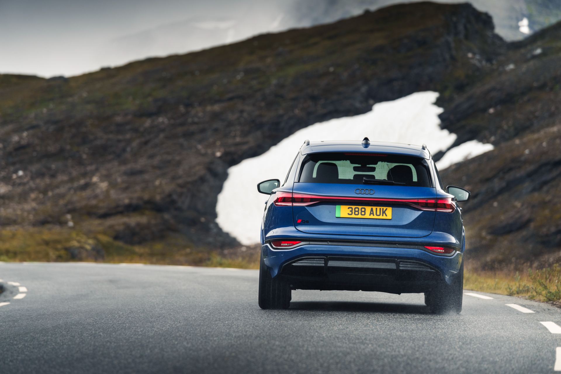 2026 audi q6 e tron driving rear blue