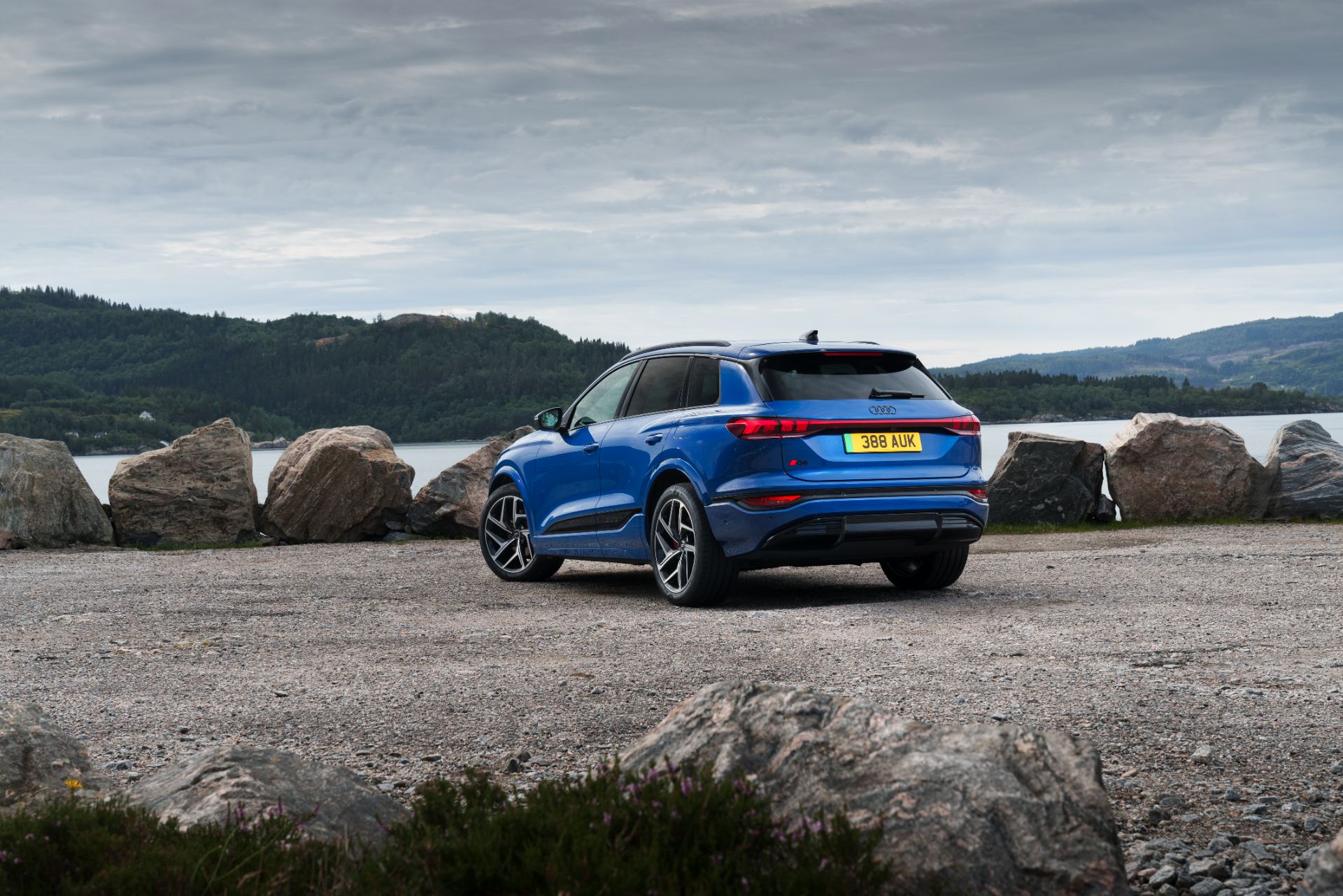 2026 audi q6 e tron rear three quarter waterfront blue