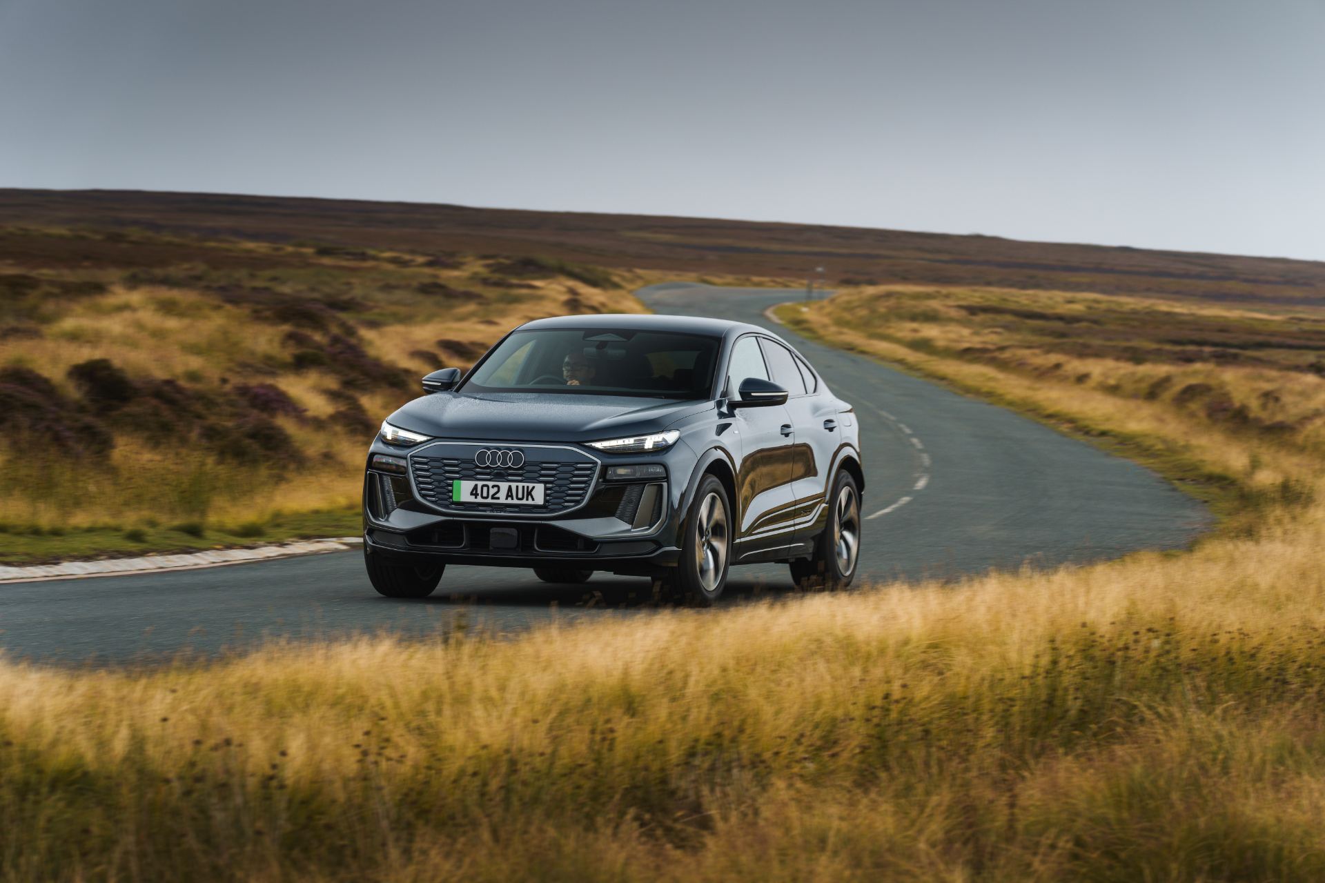 2026 audi q6 sportback e tron driving front three quarter grey