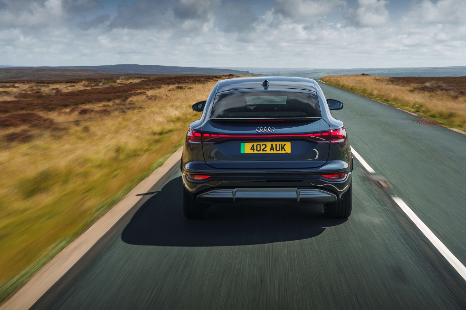 2026 audi q6 sportback e tron driving rear grey