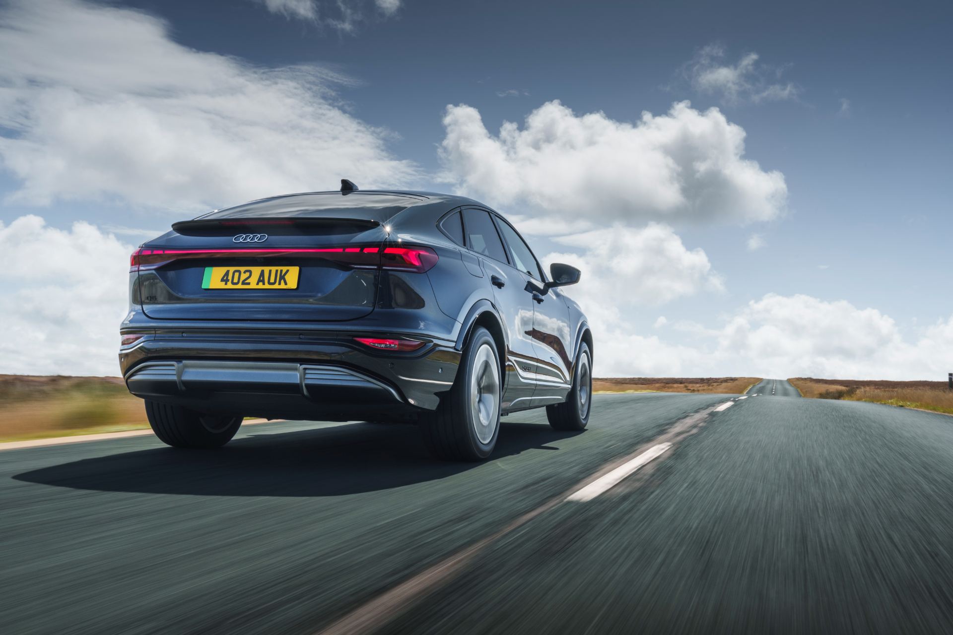 2026 audi q6 sportback e tron driving rear low angle grey