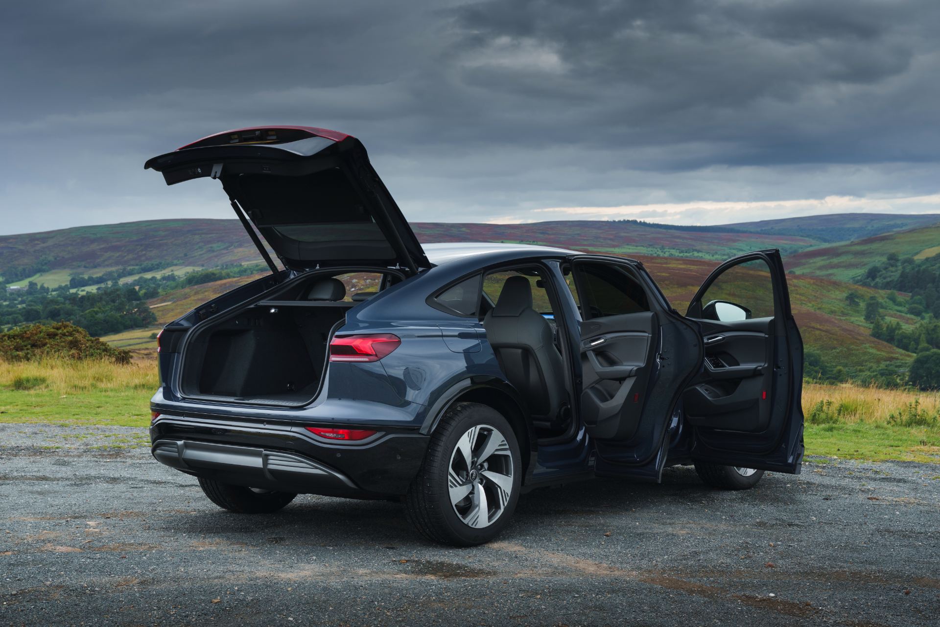 2026 audi q6 sportback e tron rear three quarter doors open grey