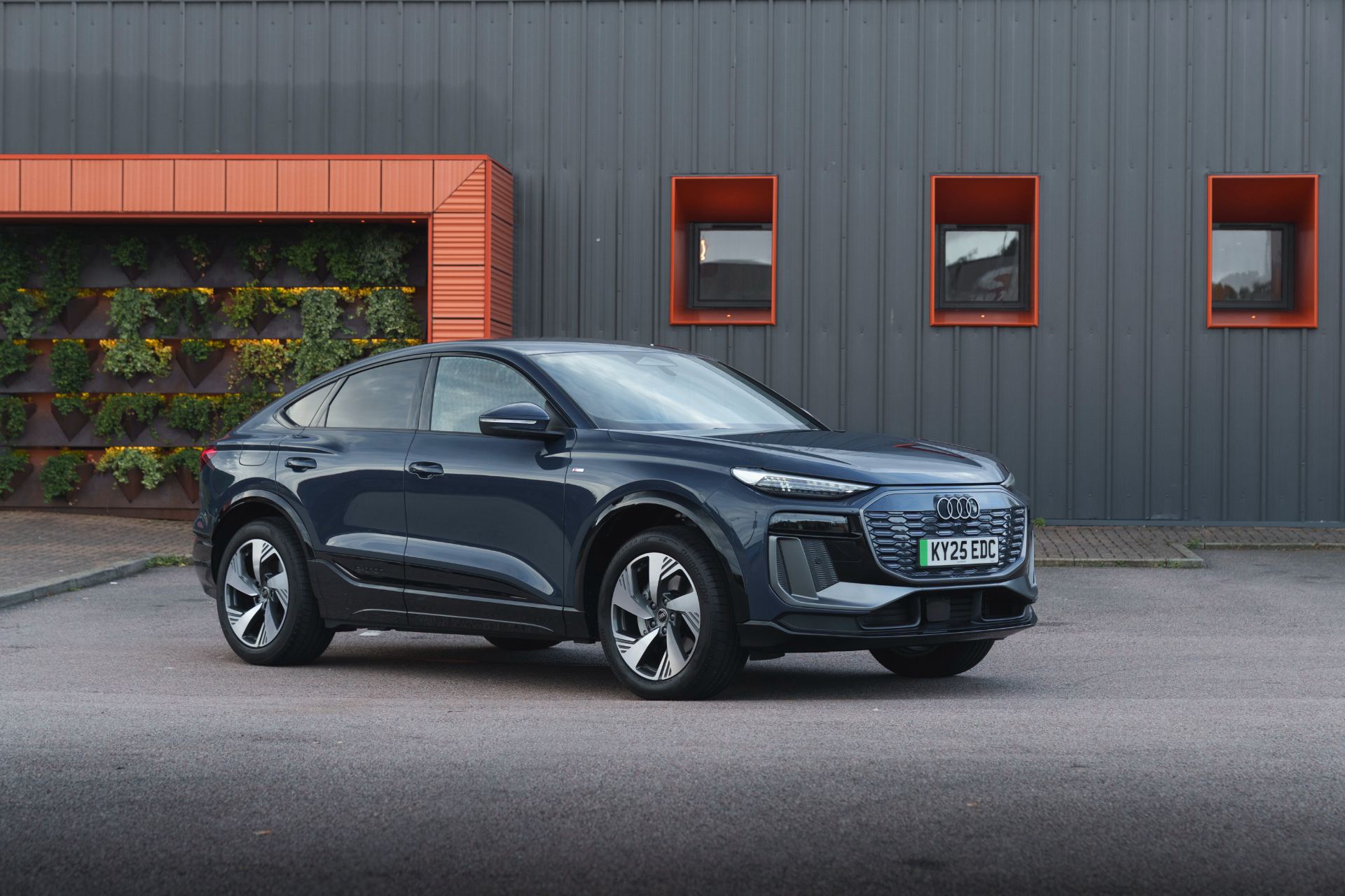 2026 audi q6 sportback e tron front three quarter building grey