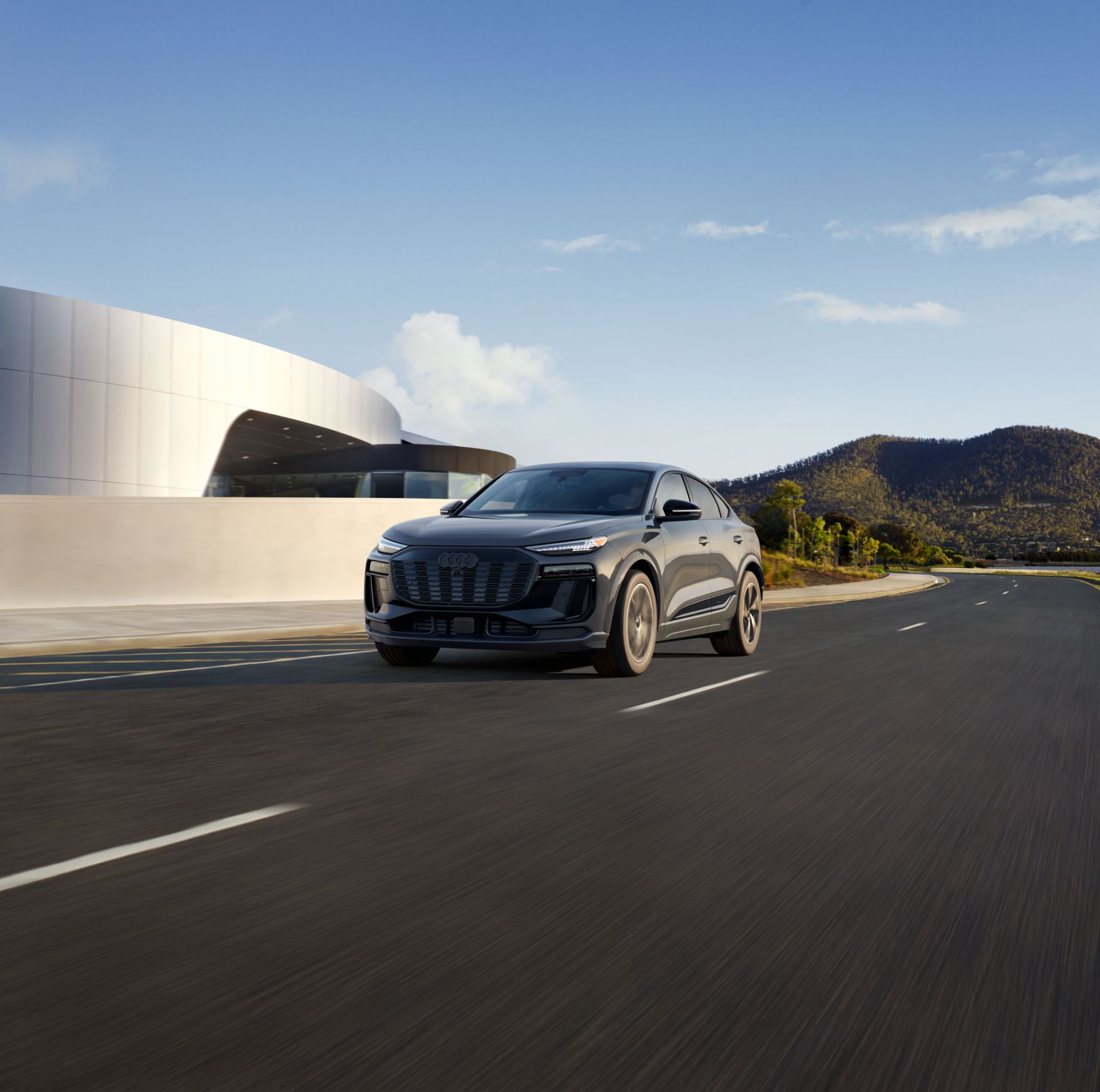 2027 audi q6 sportback e tron driving front three quarter grey