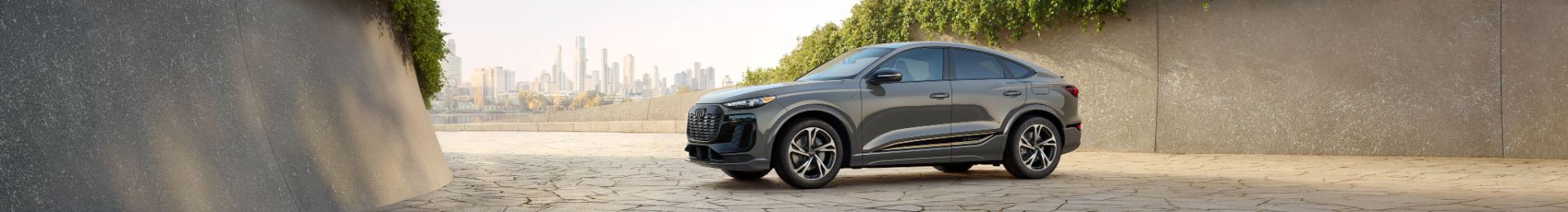 2027 audi q6 sportback e tron side profile stone courtyard wide grey