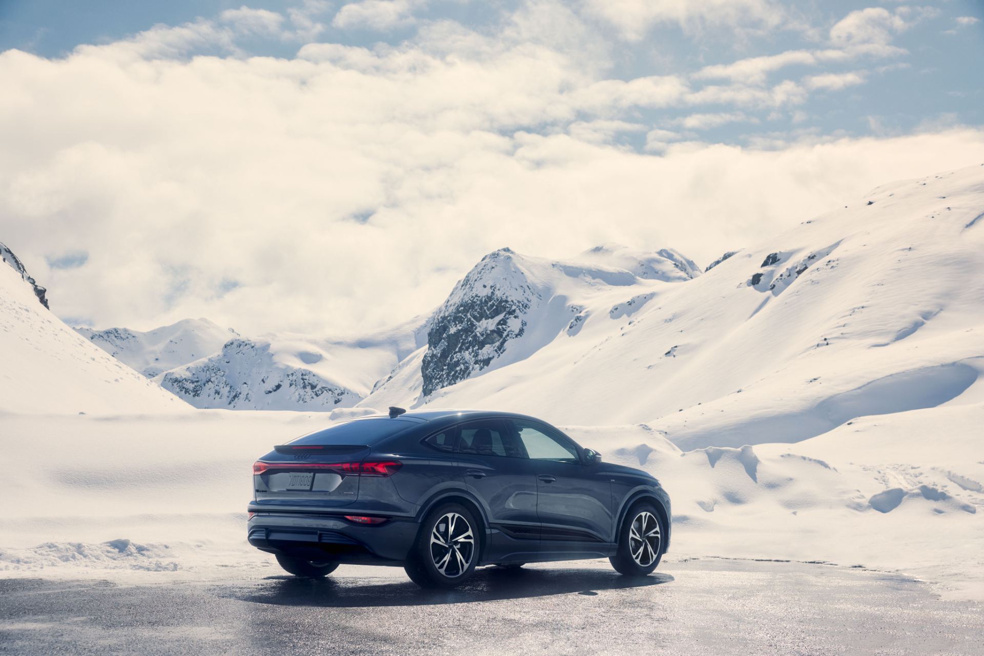 2027 audi q6 sportback e tron rear three quarter snow mountains grey