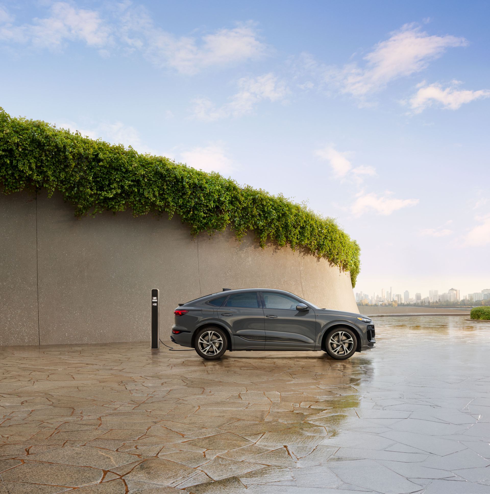 2027 audi q6 sportback e tron side profile charging courtyard grey