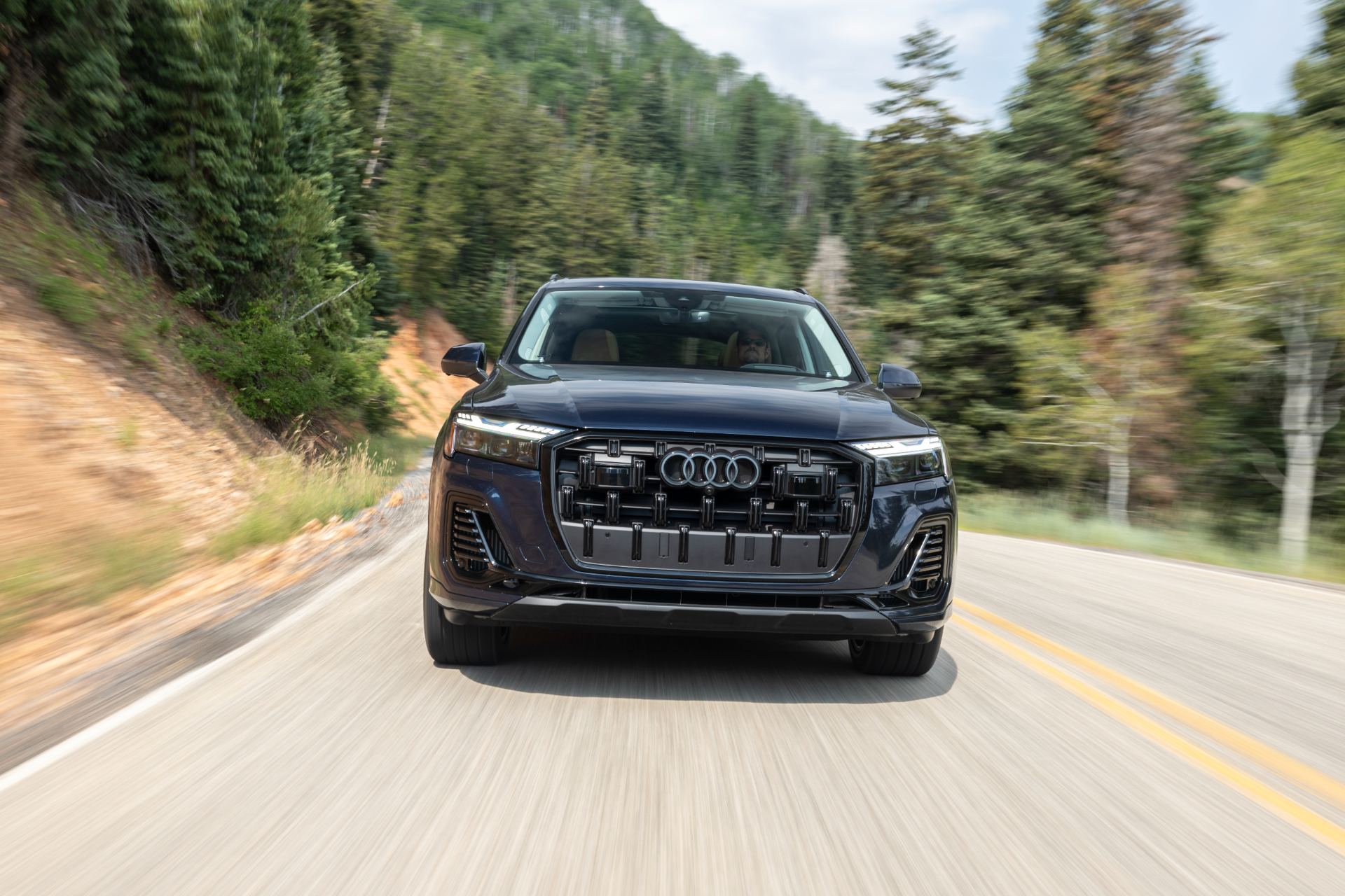 2026 audi q7 driving front forest road blue