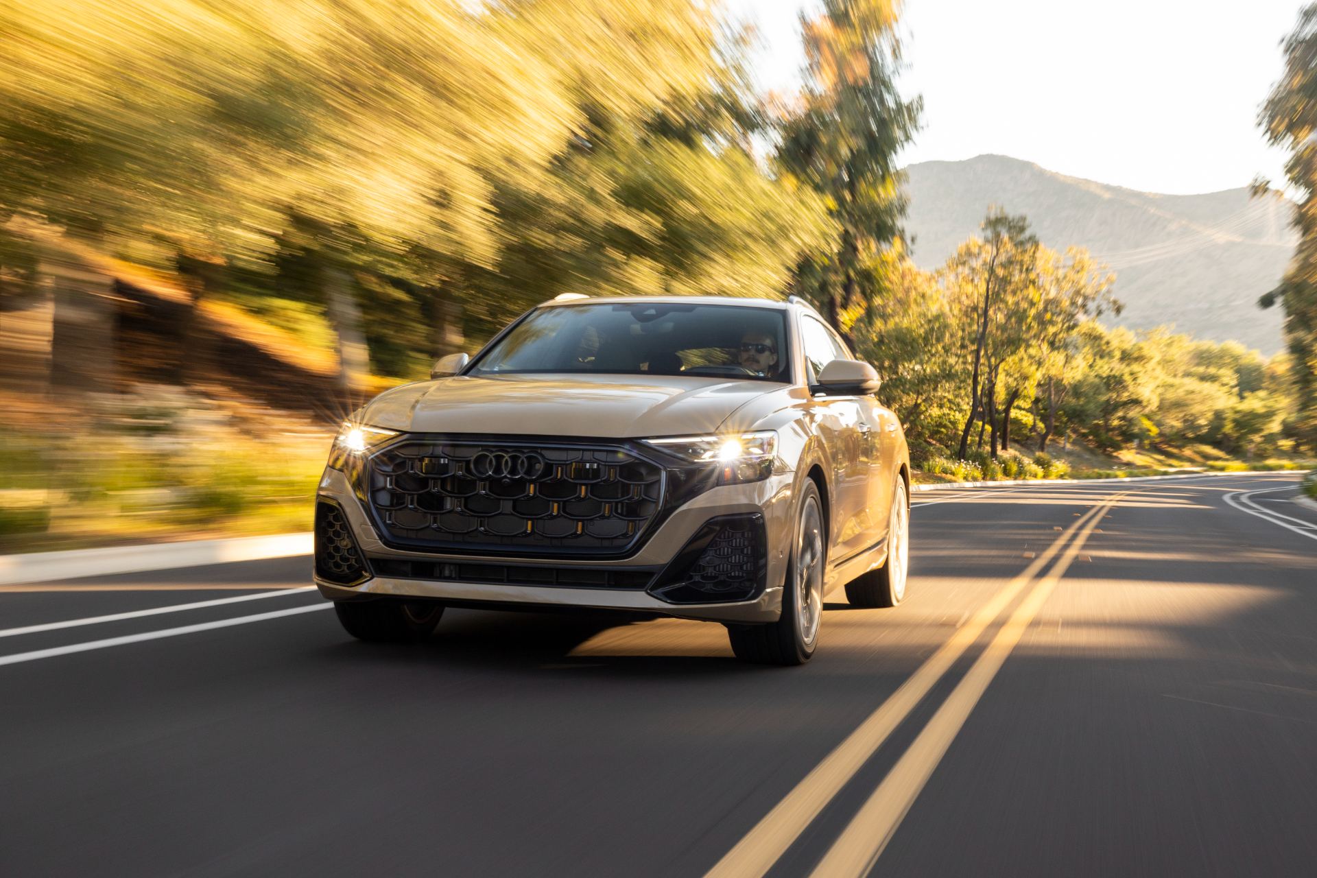 2027 audi q8 driving front three quarter beige