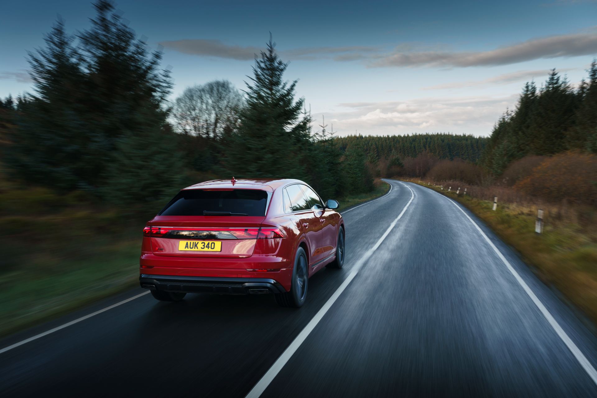 2026 audi q8 suv driving rear forest red