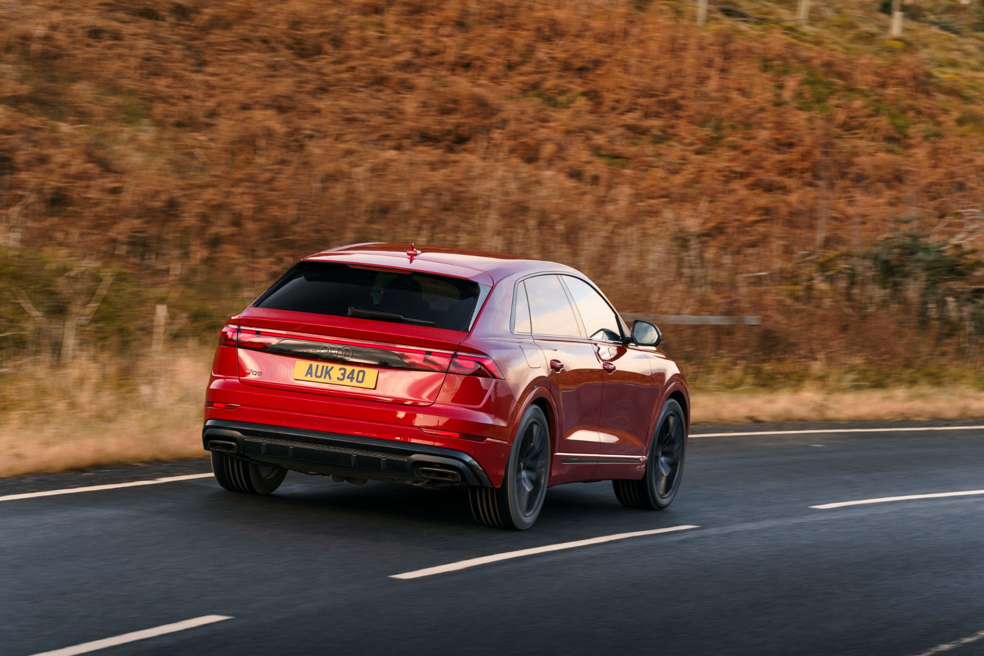 2026 audi q8 suv driving rear three quarter red