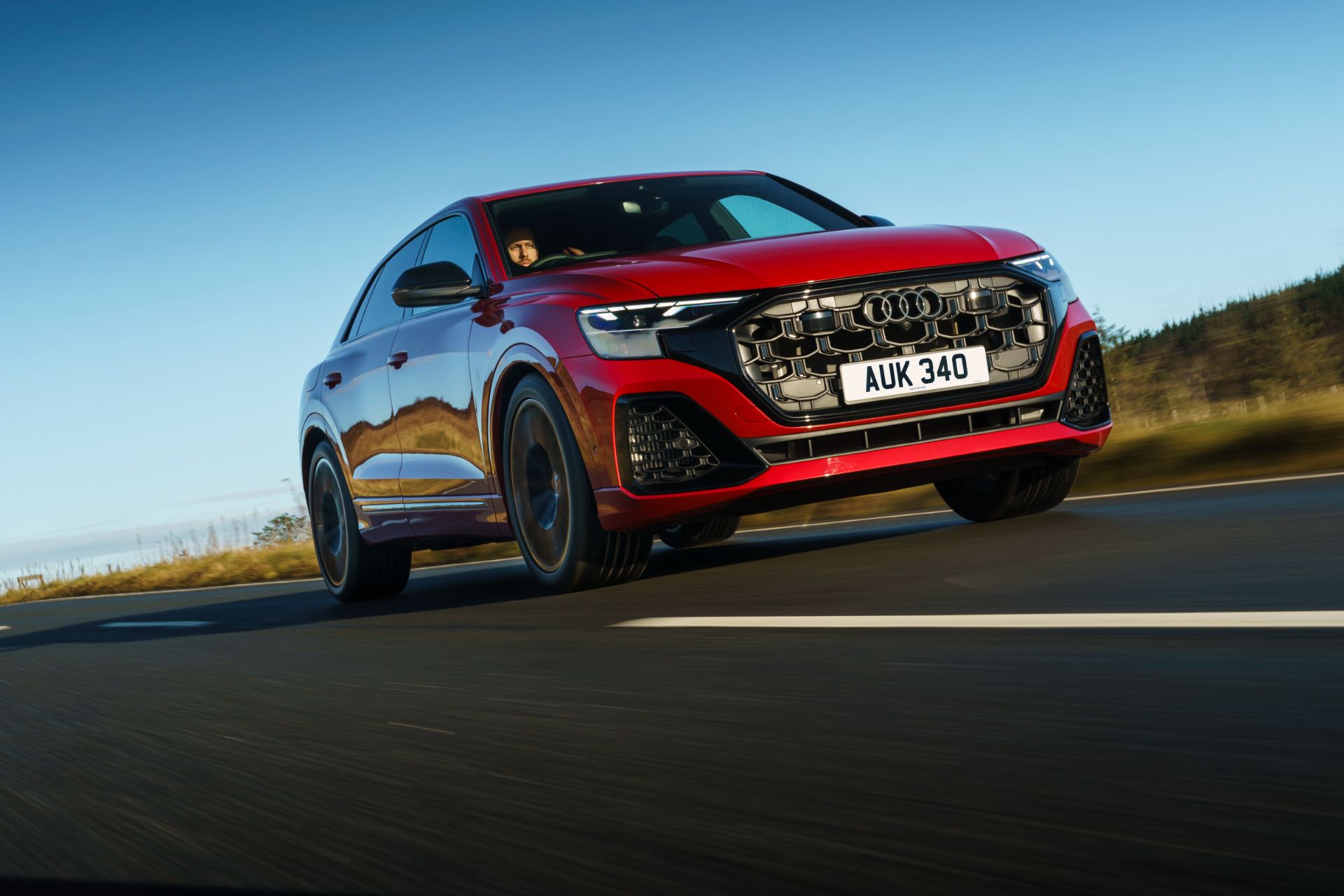 2026 audi q8 suv driving front three quarter low angle red