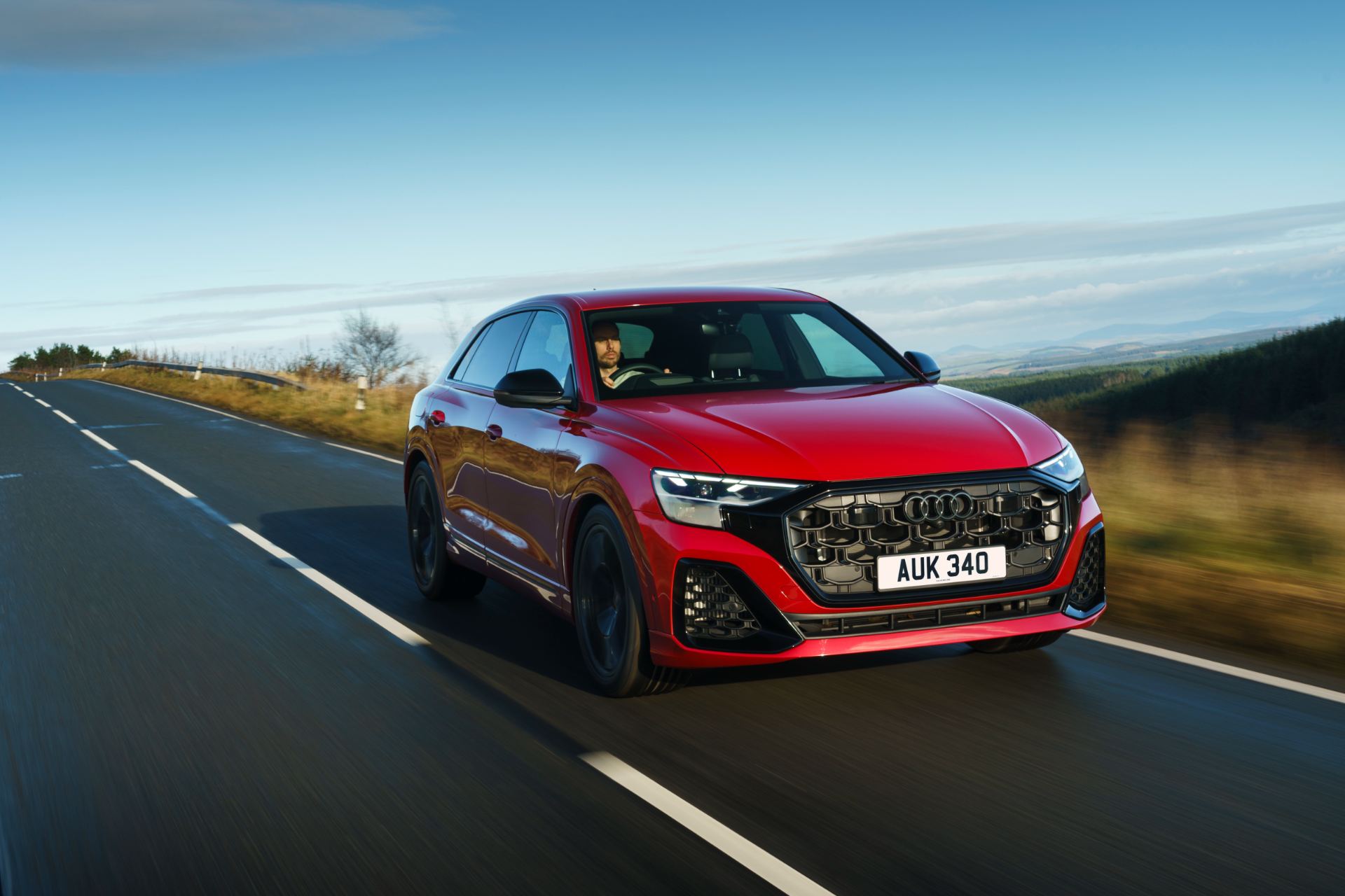 2026 audi q8 suv driving front three quarter red