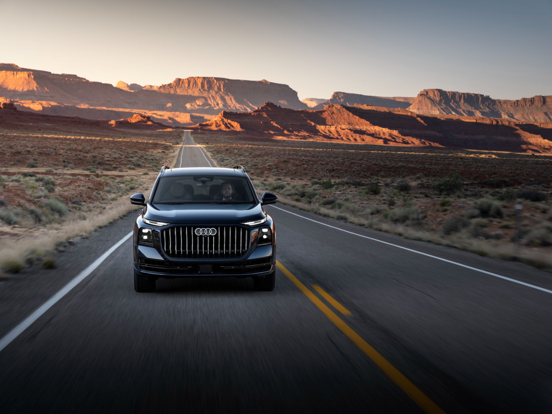 2027 audi q9 driving front desert blue