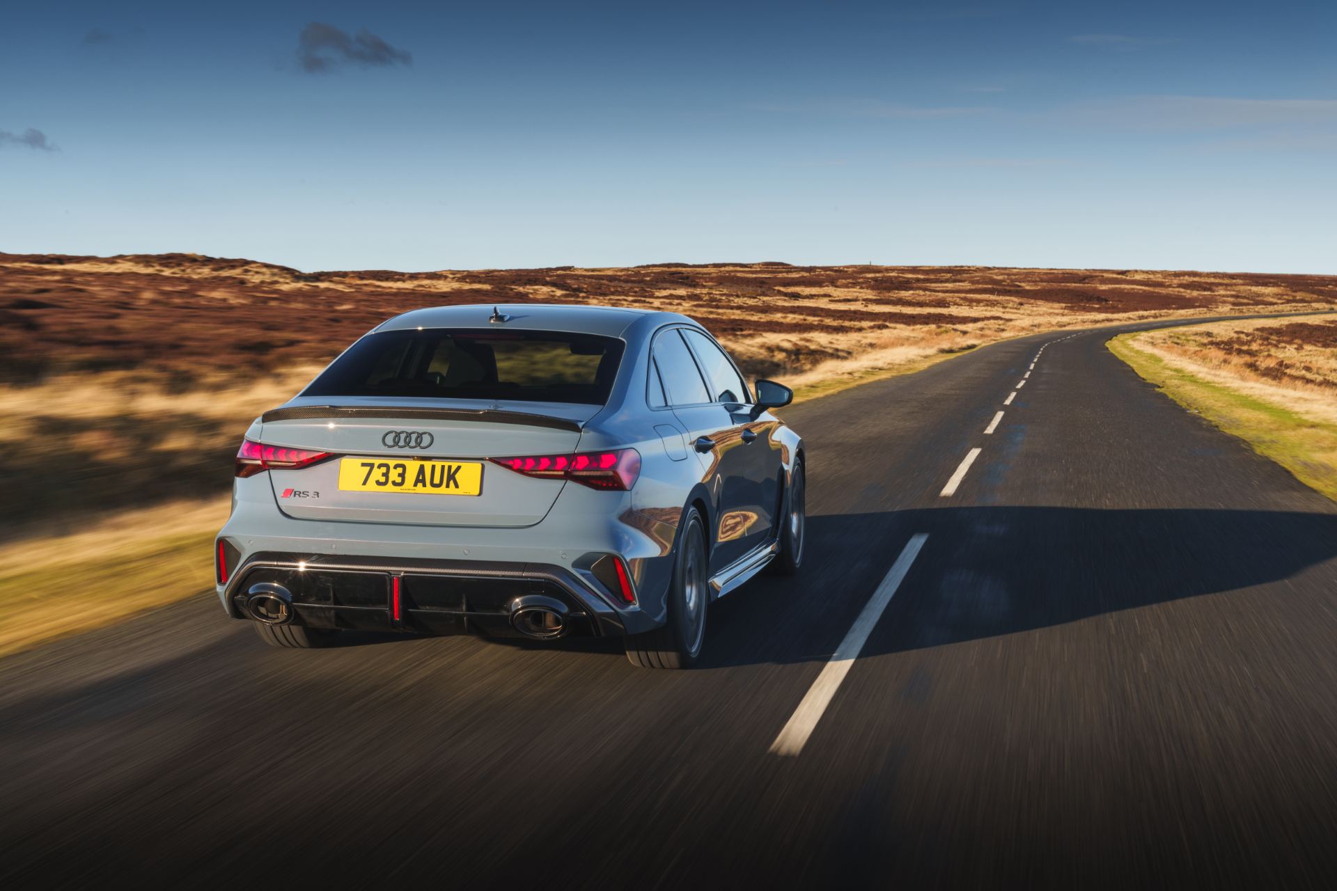 2025 audi rs 3 saloon driving rear moorland road grey