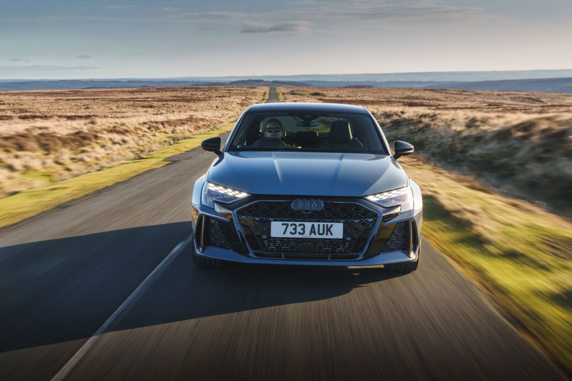 2025 audi rs 3 saloon driving front moorland road grey