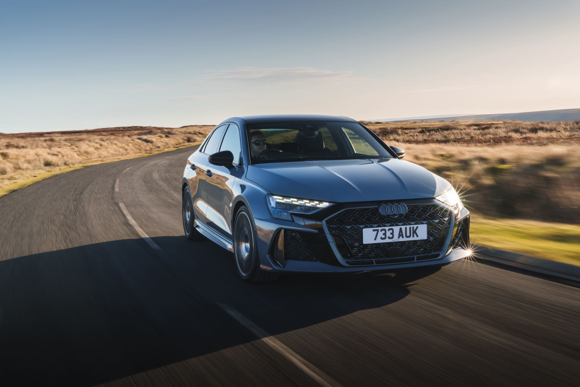 2025 audi rs 3 saloon driving front three quarter bend grey