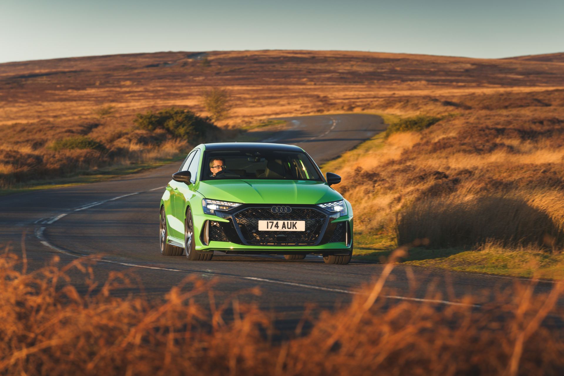 2025 audi rs 3 sportback driving front moorland bend green