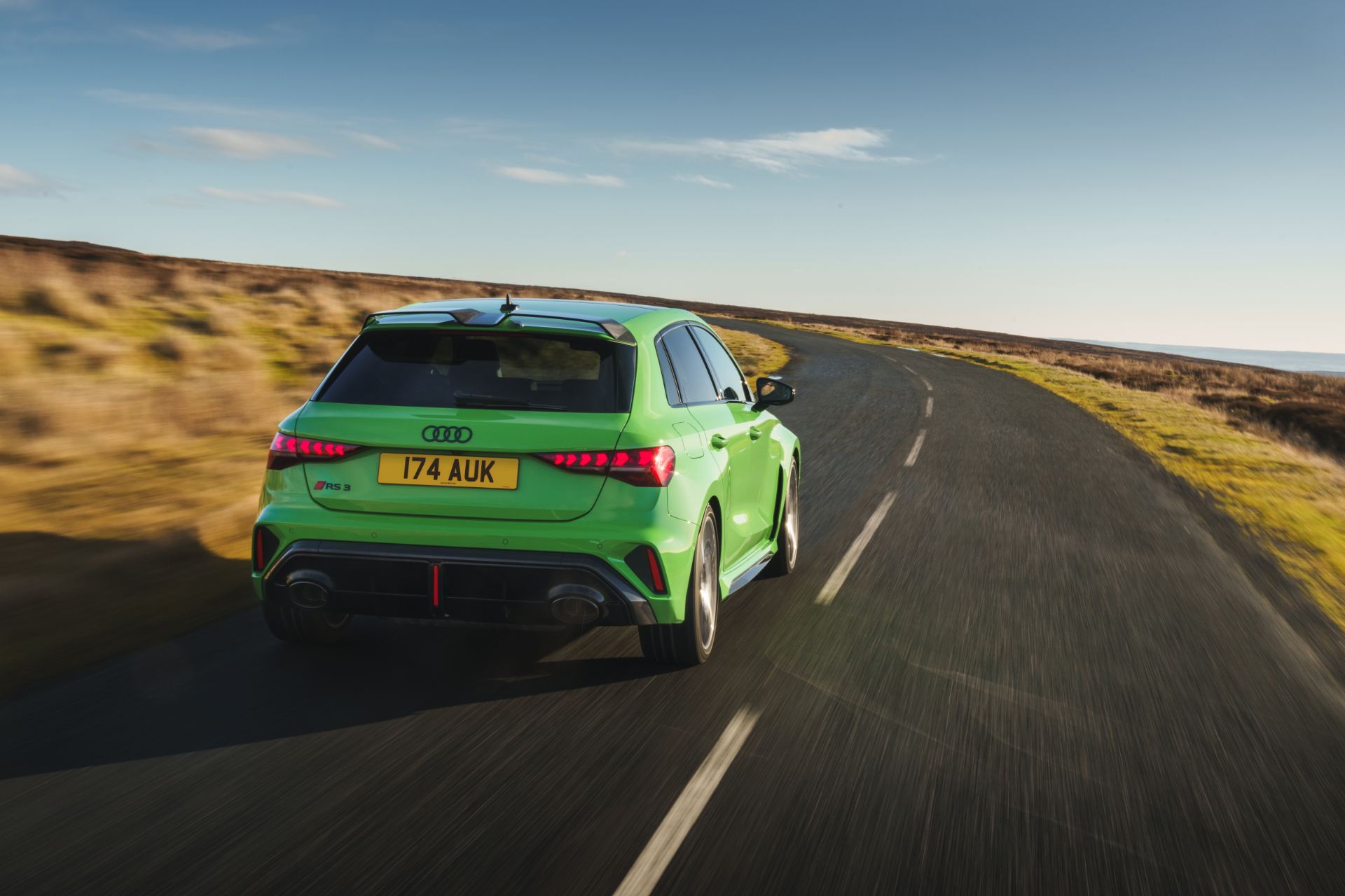 2025 audi rs 3 sportback driving rear moorland road green