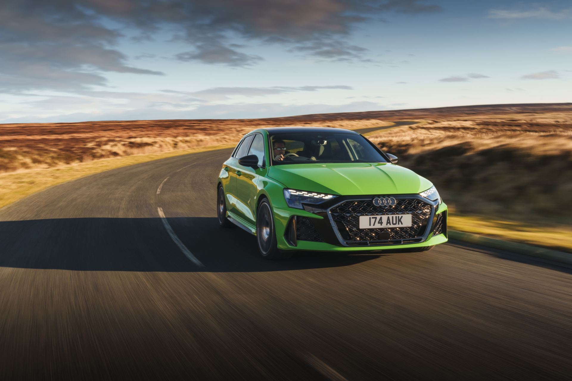 2025 audi rs 3 sportback driving front three quarter bend green