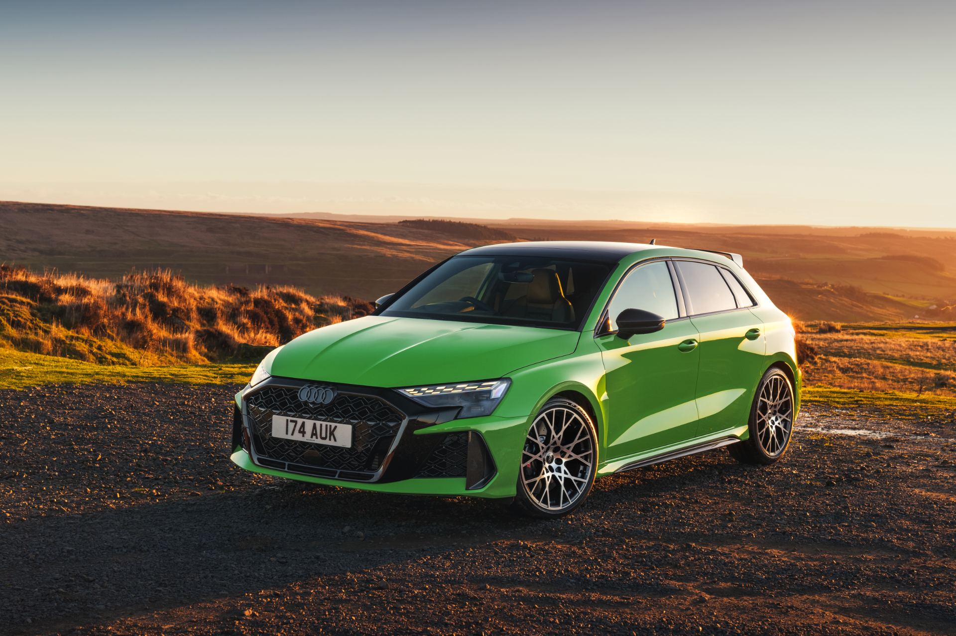 2025 audi rs 3 sportback front three quarter sunset green