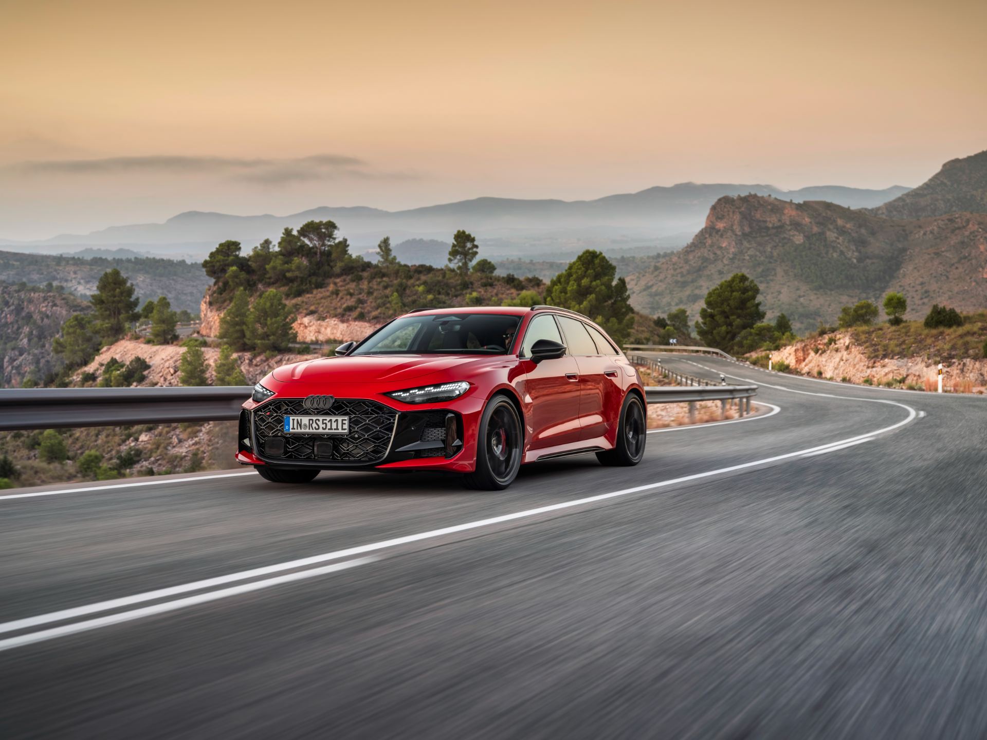 2026 audi rs 5 avant driving front three quarter mountain road red