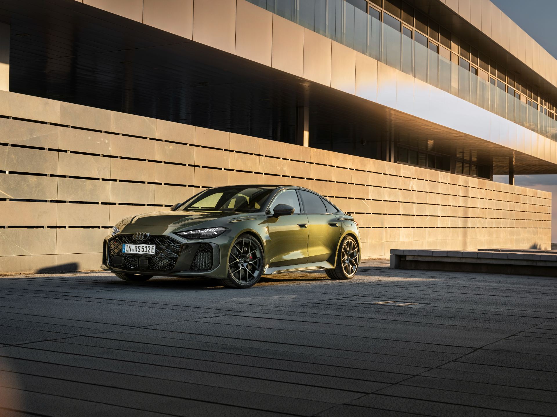 2026 audi rs 5 front three quarter building low angle green