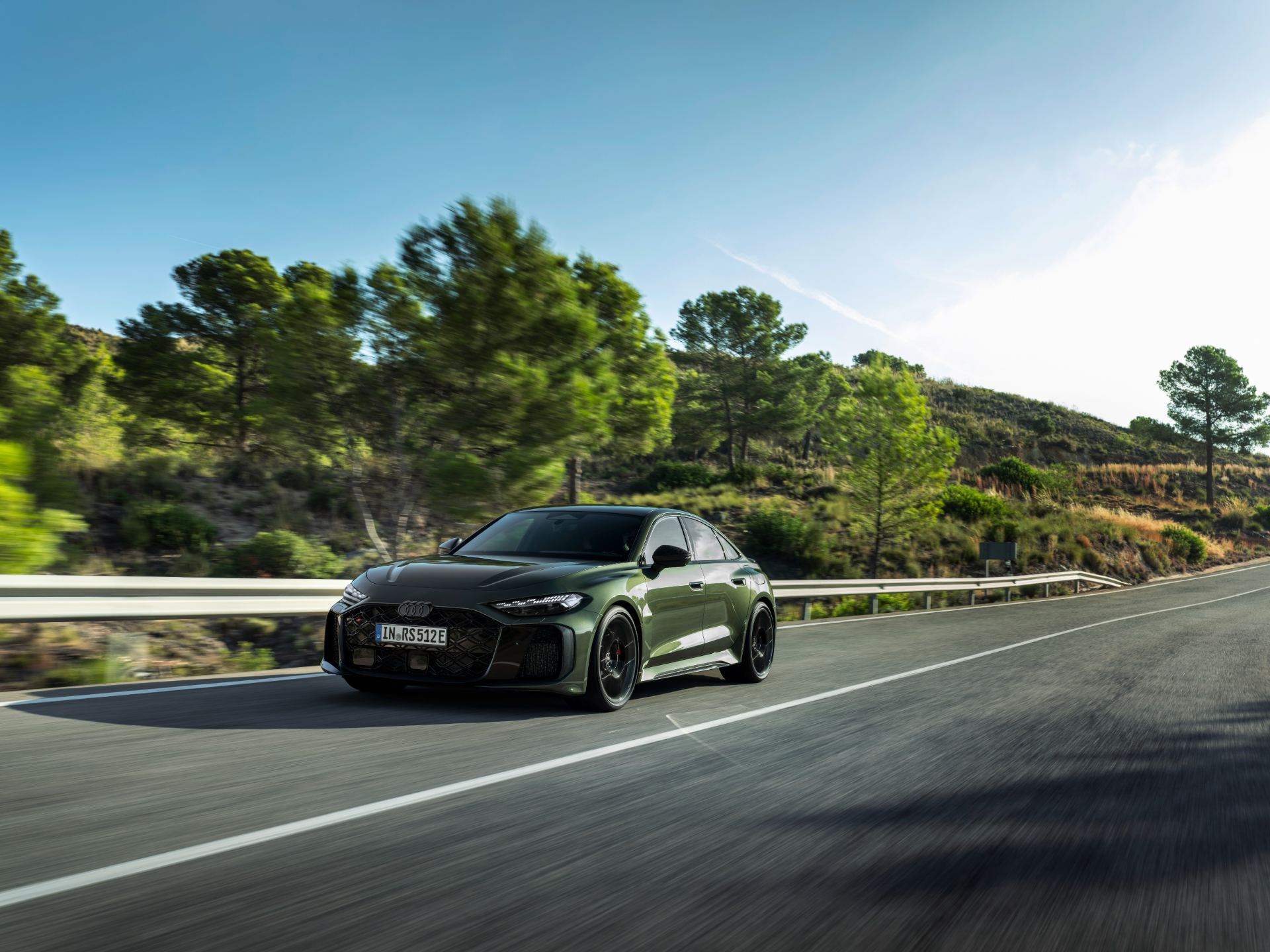 2026 audi rs 5 driving front three quarter forest road green