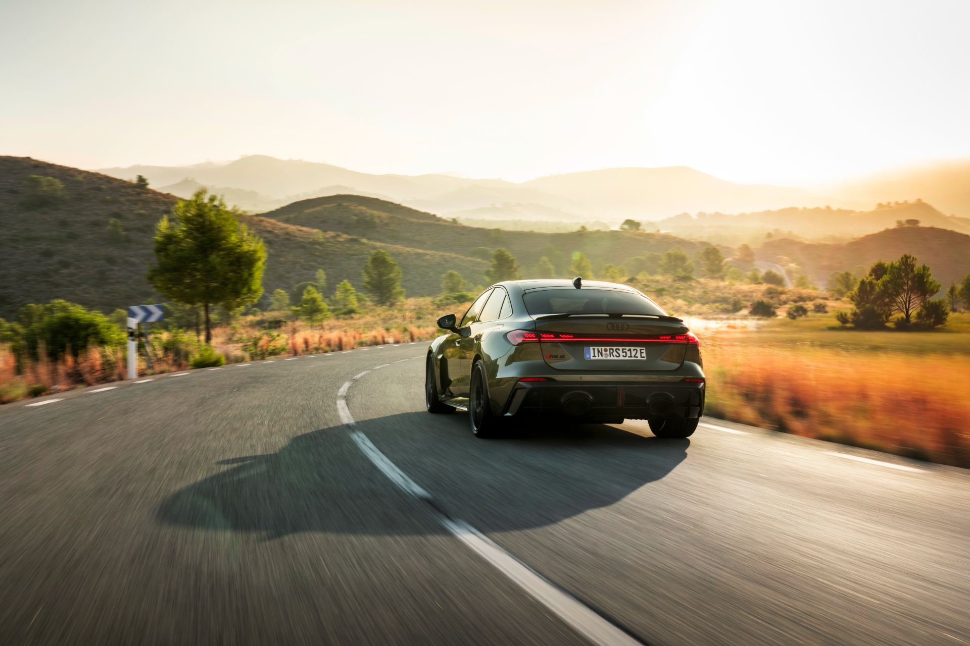 2026 audi rs 5 driving rear sunset road green