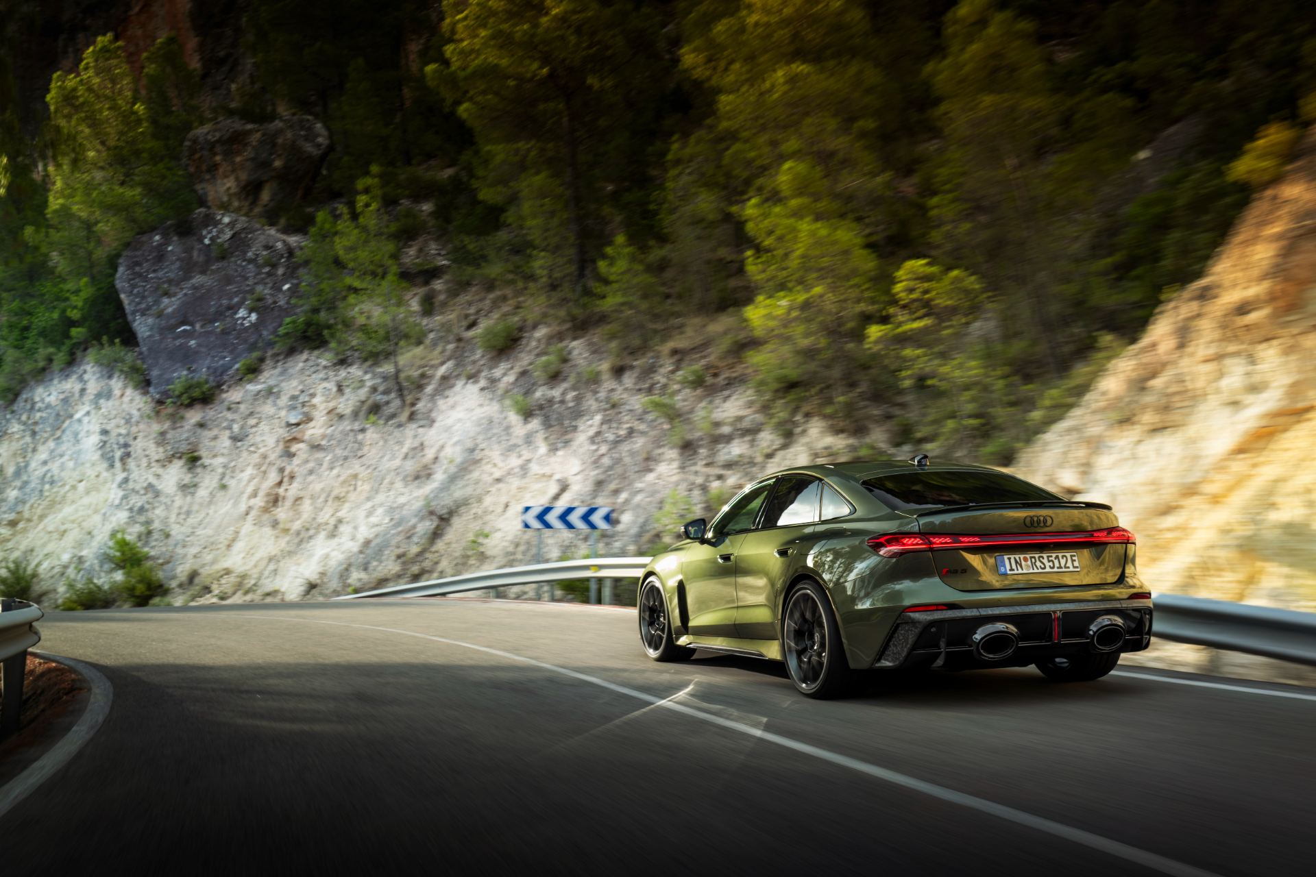 2026 audi rs 5 driving rear three quarter bend green