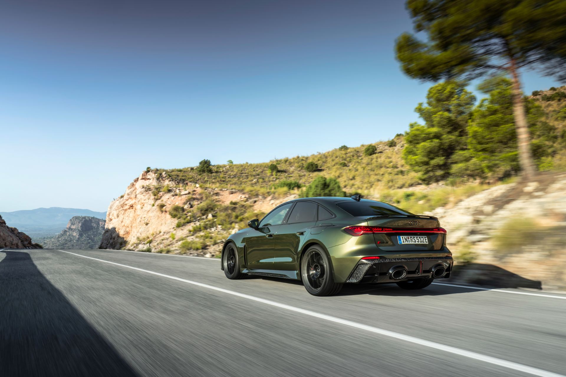 2026 audi rs 5 driving rear three quarter cliff road green