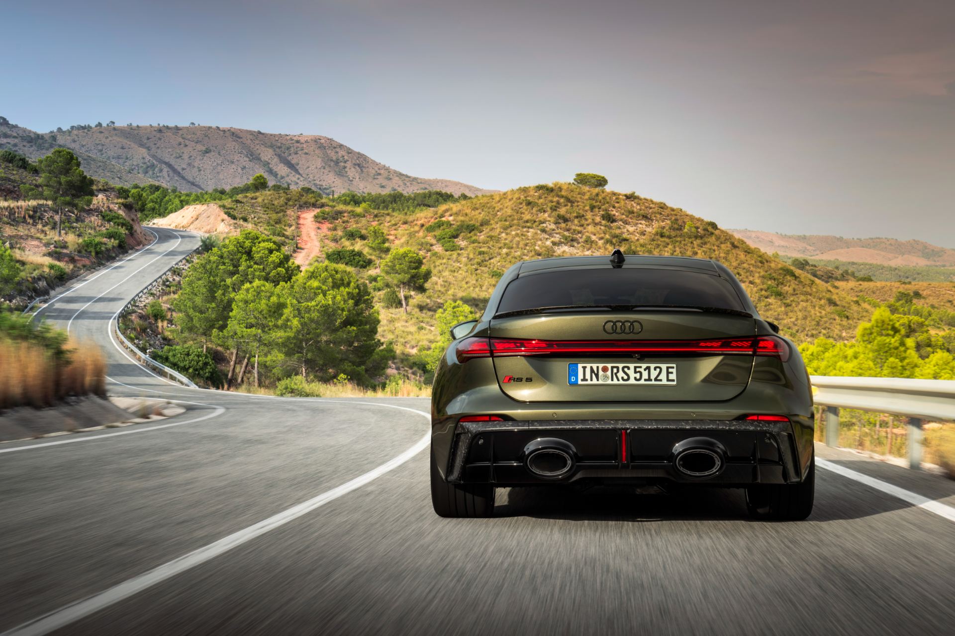 2026 audi rs 5 driving rear winding road green