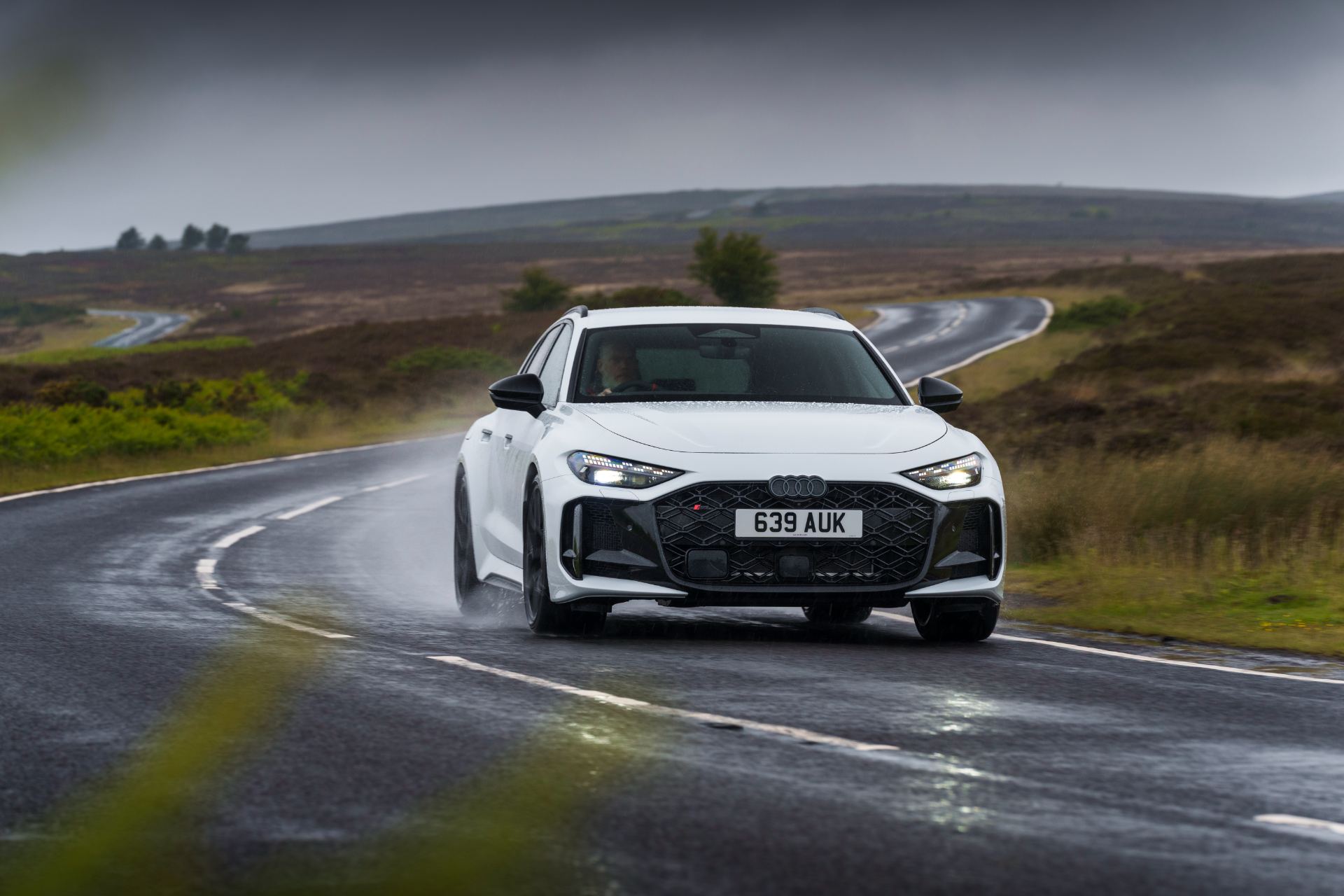 2026 audi rs 5 avant driving front wet bend white