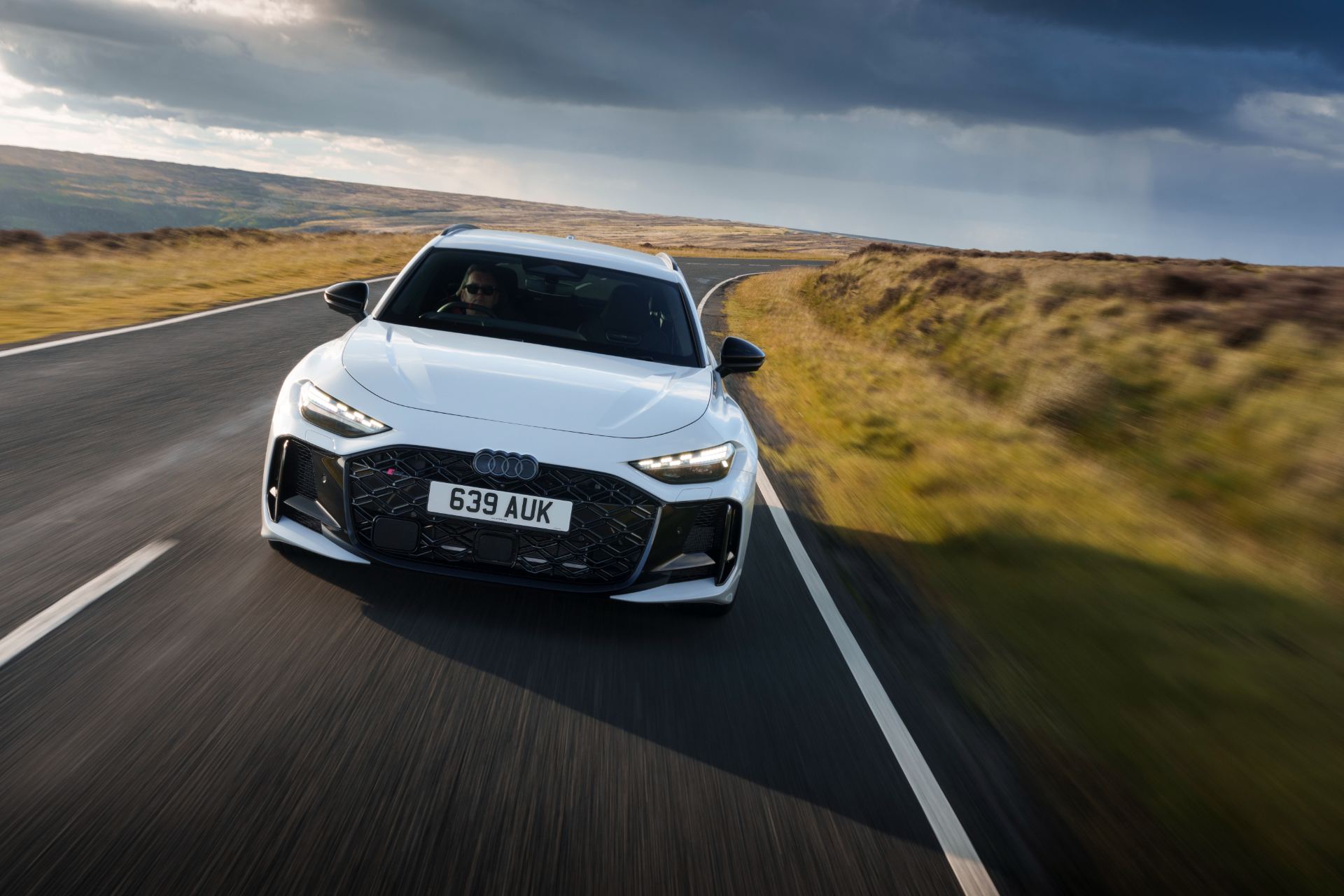 2026 audi rs 5 avant driving front moorland road white