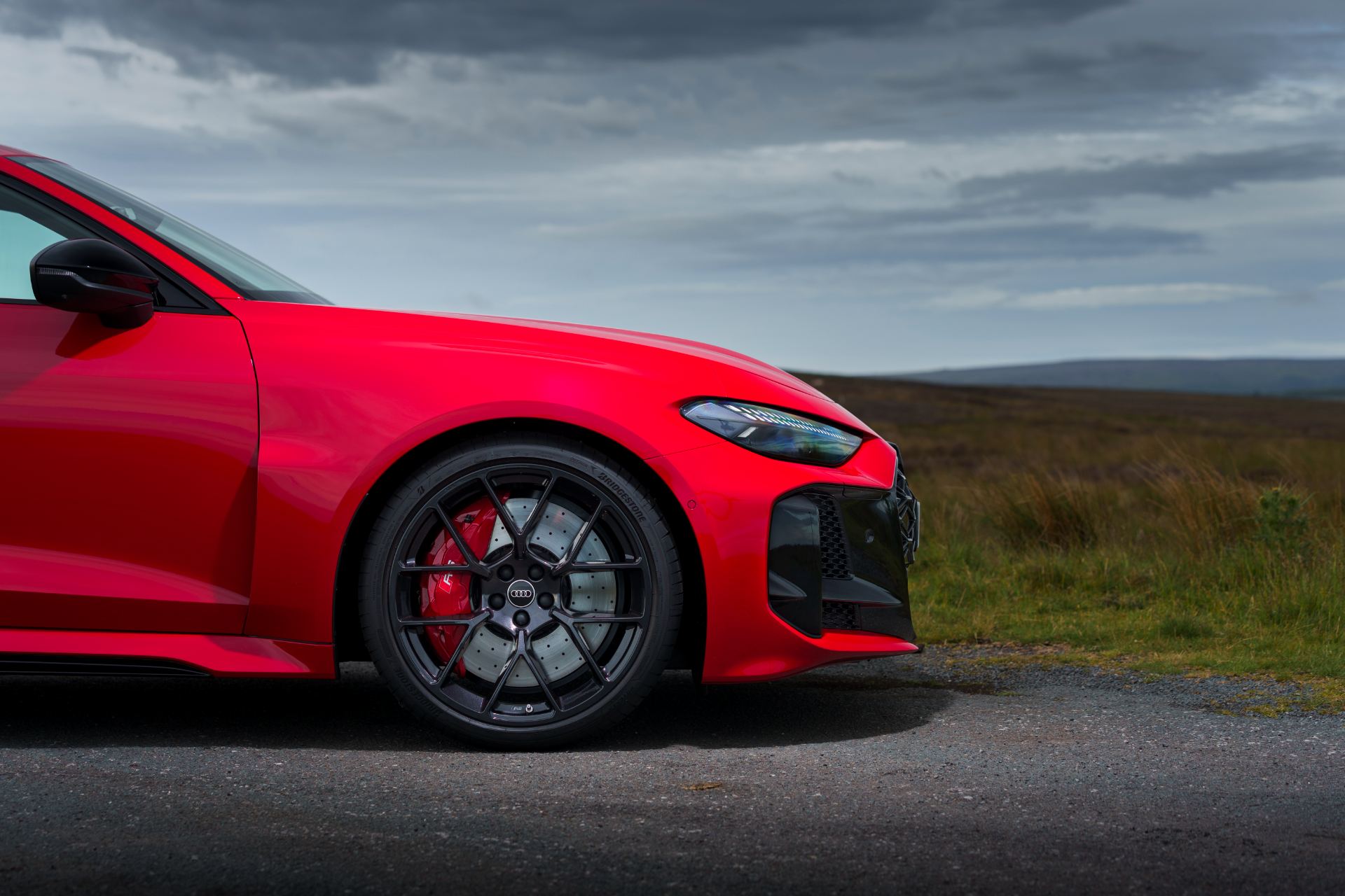 2026 audi rs 5 saloon front quarter red brake caliper