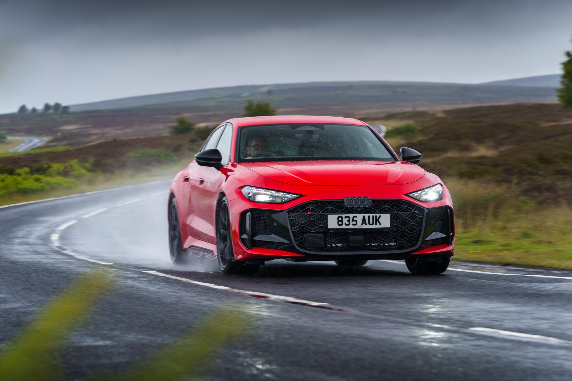 2026 audi rs 5 saloon driving front wet road red