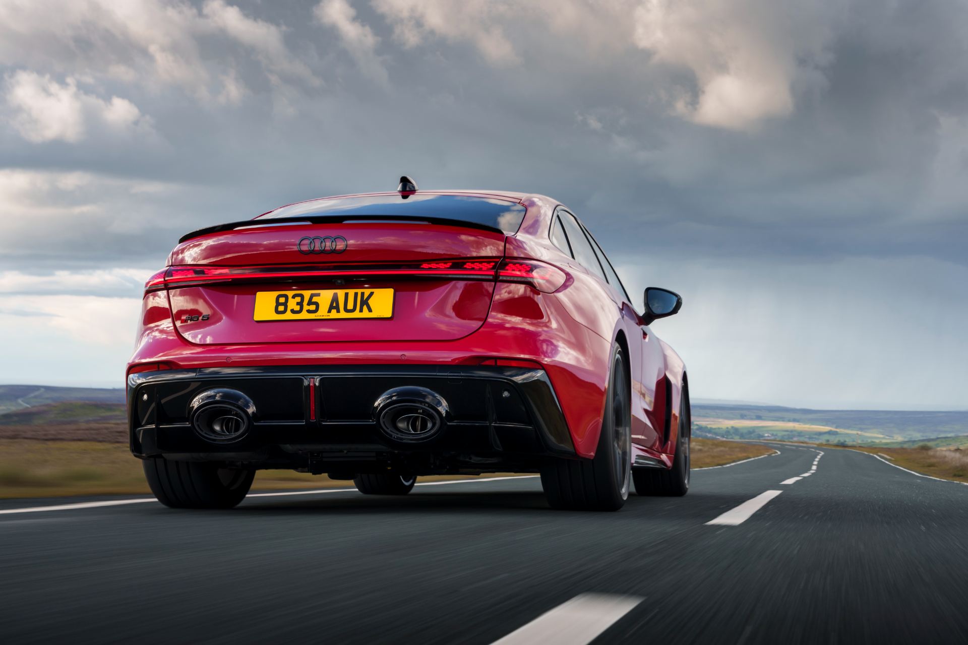 2026 audi rs 5 saloon driving rear red