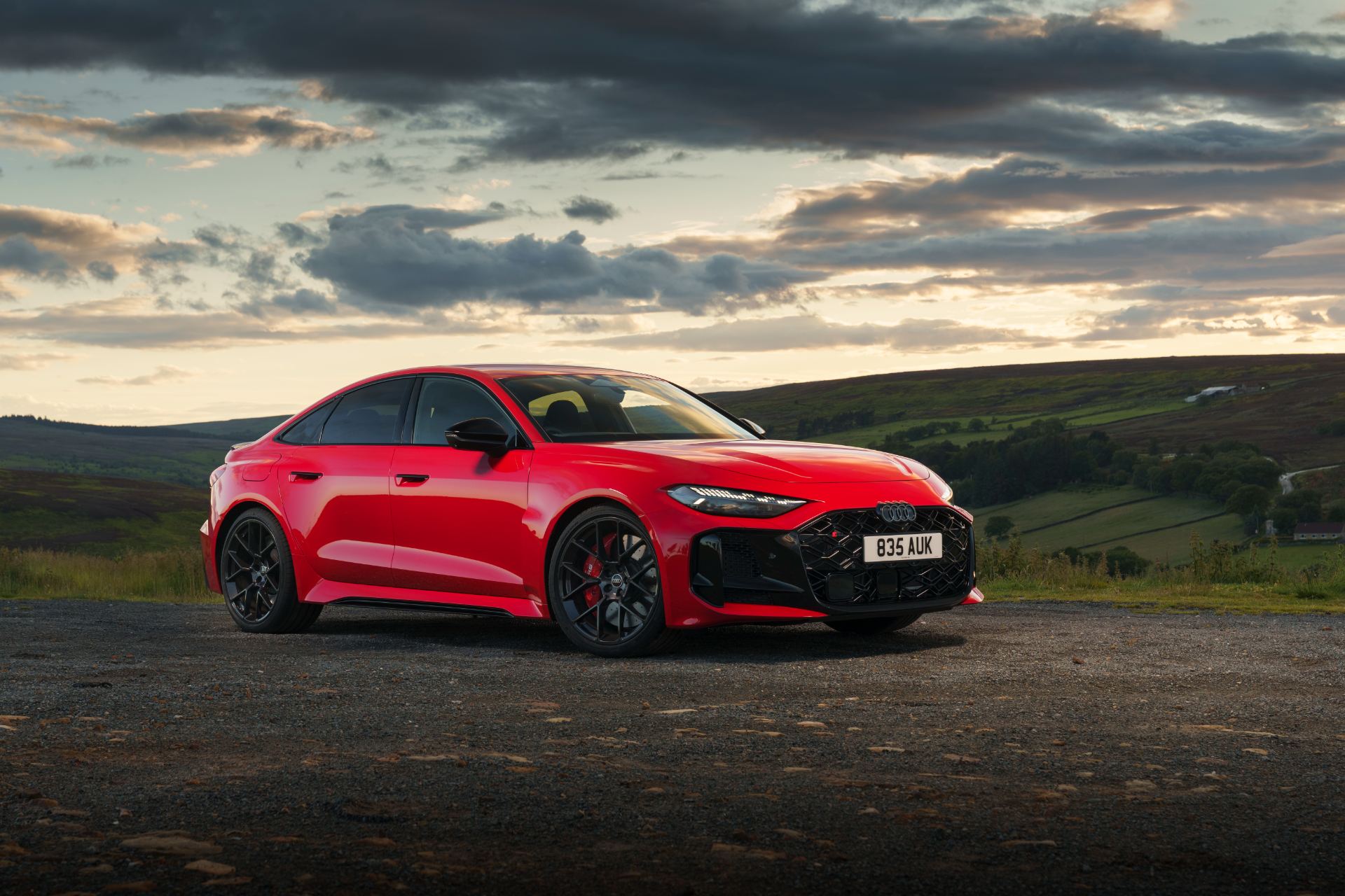 2026 audi rs 5 saloon front three quarter sunset moorland red